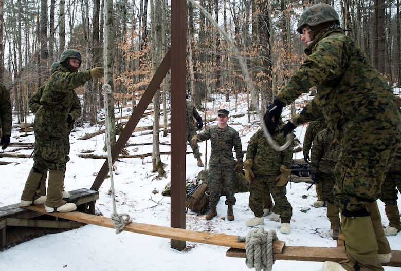 Marines with Company K, 3rd Battalion, 25th Marine Regiment, 4th Marine Division, work together to transfer supplies across a gap while participating in the Leadership Reaction Course at exercise Nordic Frost at Camp Ethan Allen Training Site in Jericho, Vt., Jan. 8. 2017. The LRC is designed to use small-unit leadership to overcome obstacles, which is one of the main focuses of the exercise. (U.S. Marine Corps photo by Cpl. Melissa Martens/ Released) 