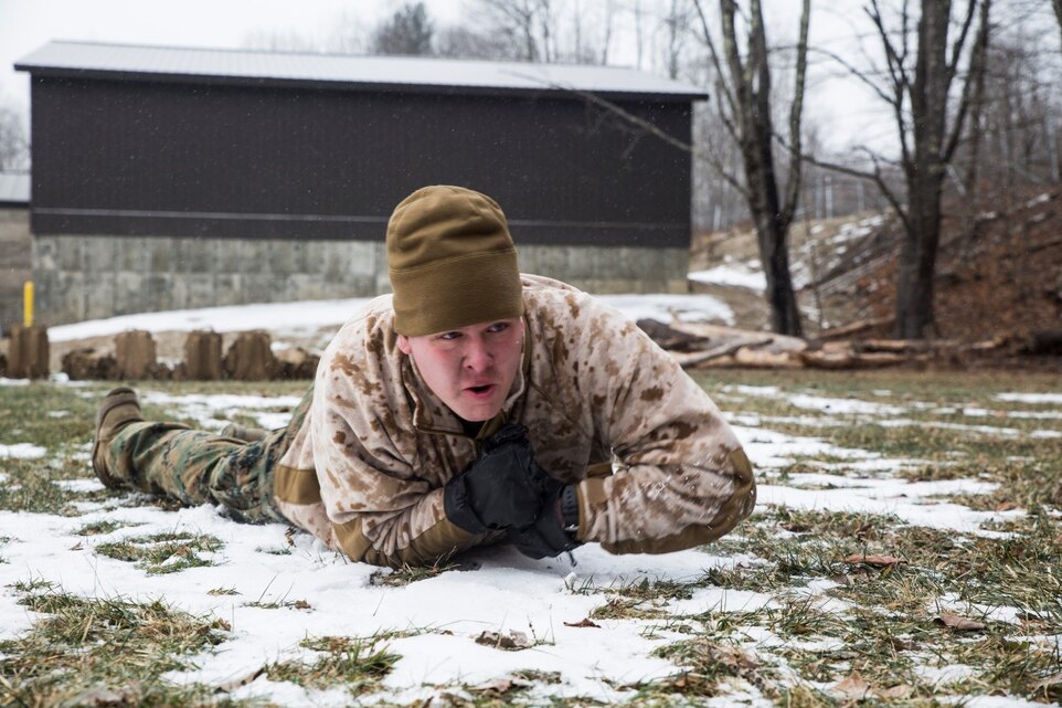 Lance Cpl. Joshua D, Burson, ground radio repair-man, Headquarters and Service Company, 3rd Battalion, 25th Marine Regiment, 4th Marine Division, low crawls during a Marine Corps Martial Arts Program course while at exercise Nordic Frost at Camp Ethan Allen Training Site in Jericho, Vt., Jan. 8. 2017. Marines were provided the opportunity to obtain their grey or green belts during the exercise. (U.S. Marine Corps photo by Cpl. Melissa Martens/ Released) 