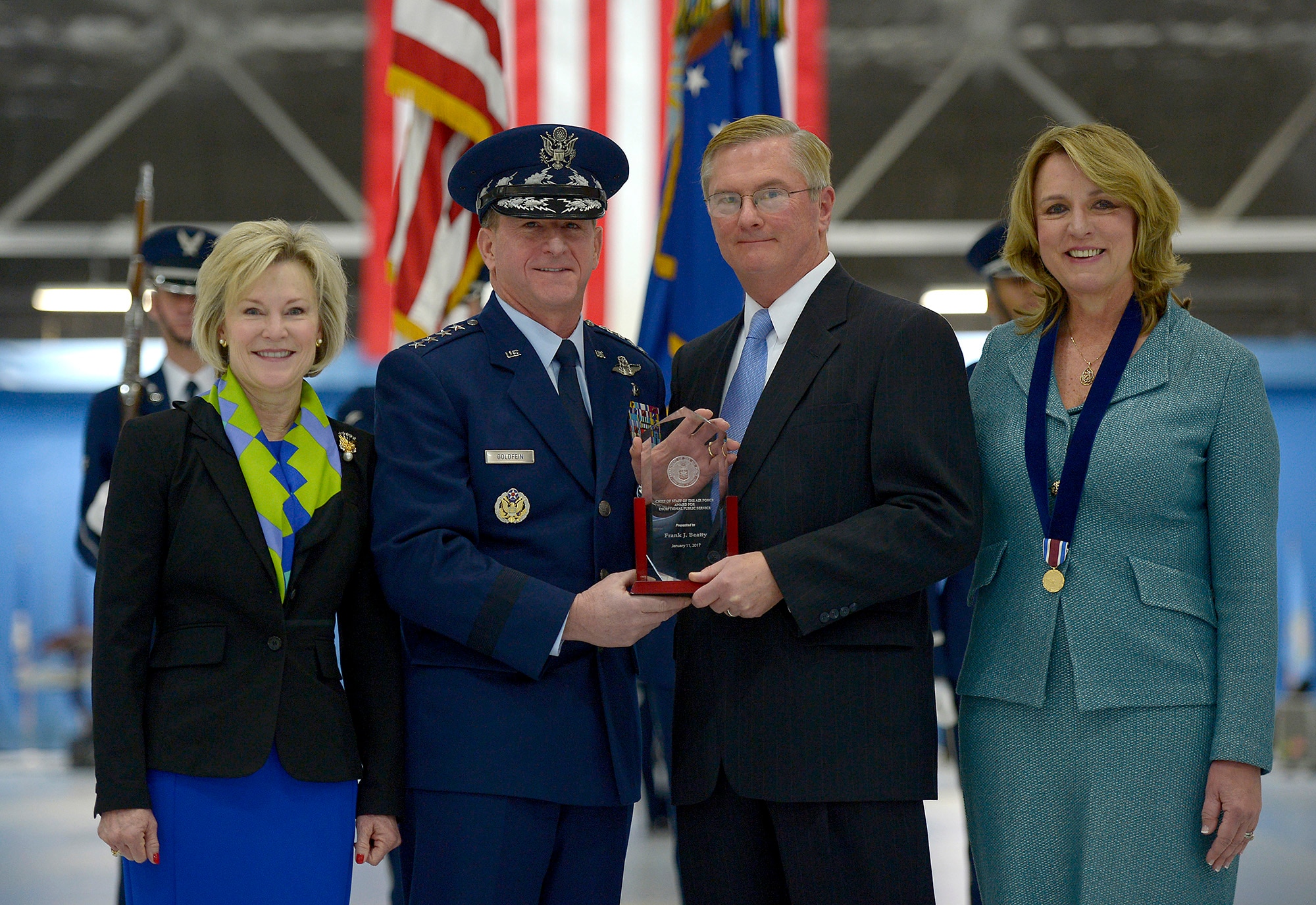 Air Force Chief of Staff Gen. David L. Goldfein and his wife, Dawn, present Frank Beatty, husband of Secretary of the Air Force Deborah Lee James, with a plaque during James' farewell ceremony at Joint Base Andrews, Md., Jan. 11, 2017.  James took office as the 23rd secretary of the Air Force in December 2013. (U.S. Air Force photo/Tech. Sgt. Joshua L. DeMotts)