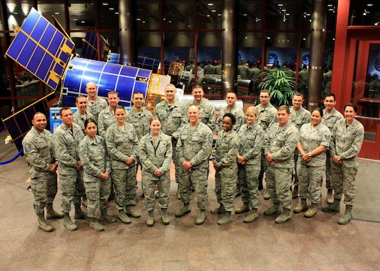 Total Force Airmen, left to right, front to back, Master Sgt. Eric Morales, Maj. David Usilton, Senior Airman Cheryl Ellison, Senior Airman Alexa Gerard, Maj. Sarah Ford, Master Sgt. John Fairman, Staff Sgt. Kayla Meeks, Master Sgt. Alexandra Goodwin, Maj. Jonathan Shycko, Staff Sgt. Casandra Cabral, Maj. Heather Swanson, Staff Sgt. Andrew Calvin, Master Sgt. Kevin Reed, Ronnie Harville, Tech. Sgt. Angel Santaella III, Master Sgt. Gregory Dolak, Tech. Sgt. Ryan Eanes, Senior Master Sgt. Joshua Savitt, Master Sgt. Ryan Kegebein, Master Sgt. Michael Taylor, Senior Airman Romo Miguel Jr., from the 8th Space Warning Squadron pose for a photo at the mission control station Jan. 7, 2016, on Buckley Air Force Base, Colo. For the first time in over 14 years, the 8th Space Warning Squadron and their sister squadron Detachment 1, 8th Space Warning Squadron provided a full reservist crew to man the Space-Based Missile Warning System. (Courtesy photo)
