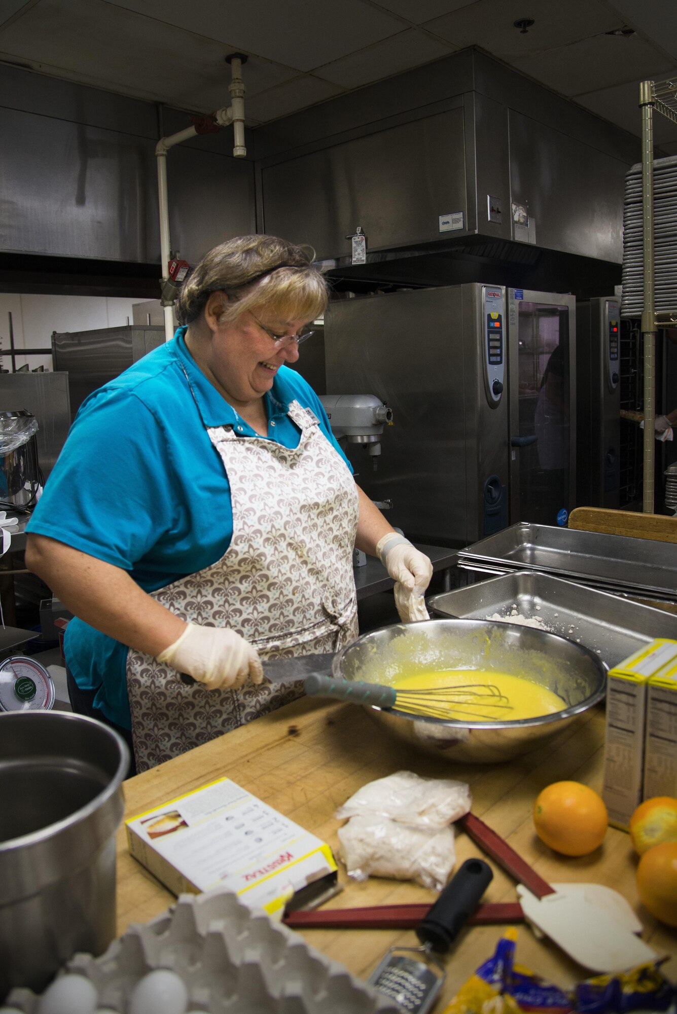 Rachel Robbins, 375th Force Support Squadron operations clerk, bakes lemon bars for Scott Air Force Base’s Centennial Celebration kick off, Jan. 5, 2017 at Scott Air Force Base, Ill.. Scott’s was constructed in 1917, creating a Scott legacy 100 years in the making. (U.S. Air Force photo by Airman 1st Class Gwendalyn Smith)