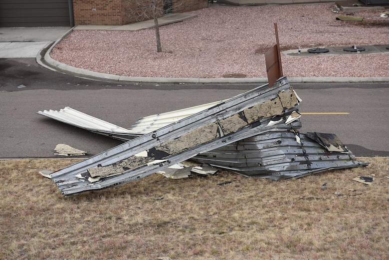PETERSON AIR FORCE BASE, Colo. – Parts to the roof of an aircraft hangar along the flightline and other debris litter the ground at Peterson Air Force Base, Colorado. A wind storm tore through the Front Range on Jan. 9, 2017 and wracked havoc on buildings, vehicles and trees. (U.S. Air Force photo by Senior Airman Rose Gudex)