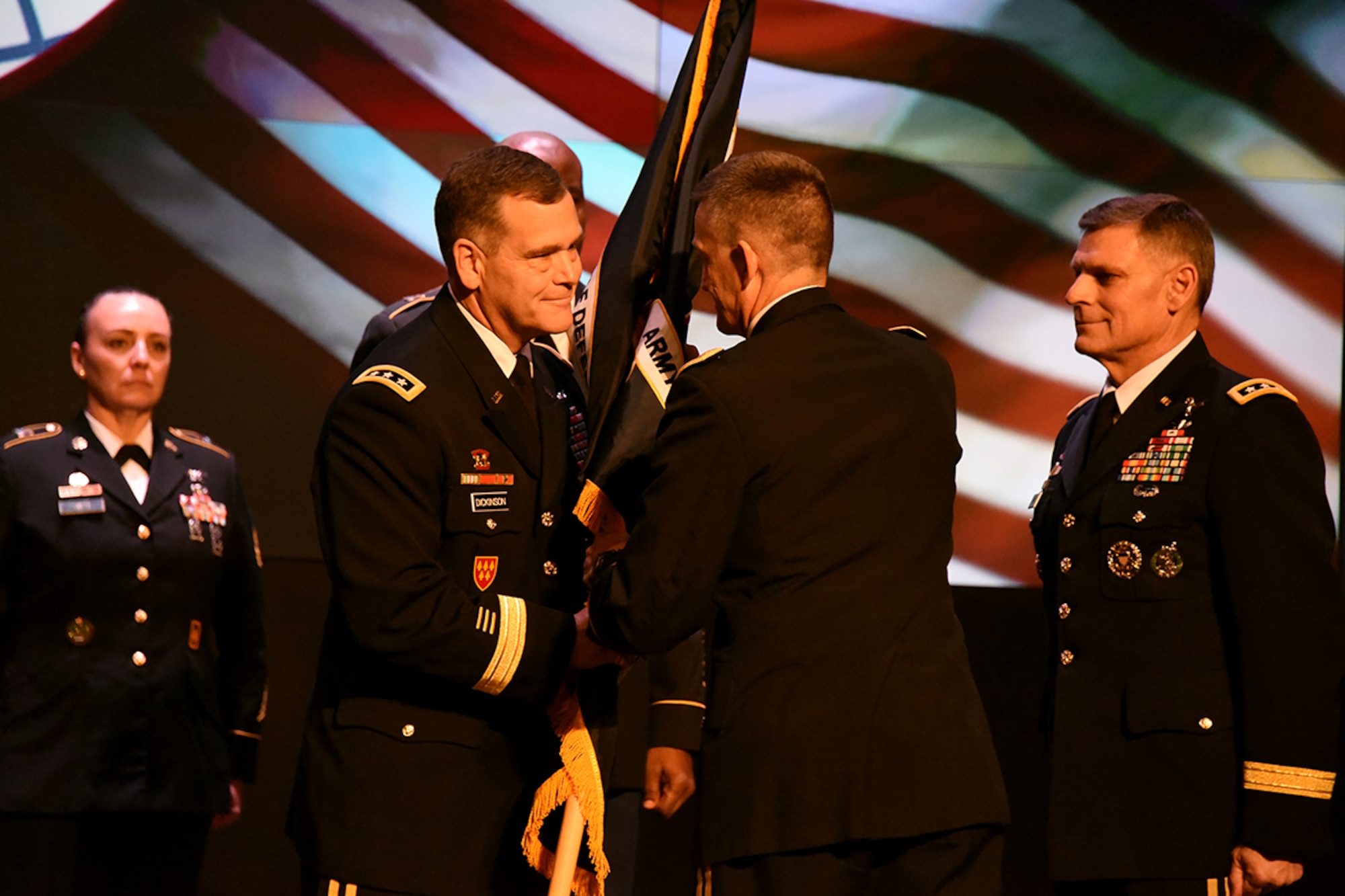 U.S. Army Gen. Daniel B. Allyn, Army vice chief of staff, passes a guidon to Army Lt. Gen. James H. Dickinson during a change of command ceremony conducted in the Von Braun III auditorium on Redstone Arsenal, Alabama, Jan. 5, 2016. Dicksinson assumed command of the Army Space and Missile Defense Command/Army Forces Strategic Command and the Joint Functional Component Command for Integrated Missile Defense. (U.S. Army photo by Carrie E. David)