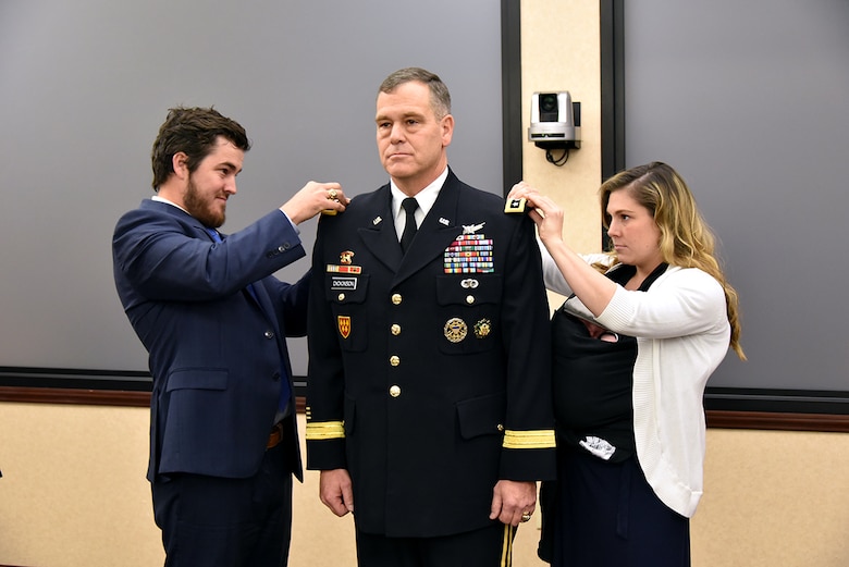 REDSTONE ARSENAL, Ala. – U.S. Army Henry "Hank" J. Dickinson and Deborah R. Weisner place three stars on the uniform of their newly promoted father, Lt. Gen. James H. Dickinson, during a ceremony at the U.S. Army Space and Missile Defense Command/Army Forces Strategic Command headquarters at Redstone Arsenal, Alabama, Jan. 5. Dickinson assumed command of SMDC and the Joint Functional Component Command for Integrated Missile Defense following his promotion. (U.S. Army photo by Jason B. Cutshaw)
