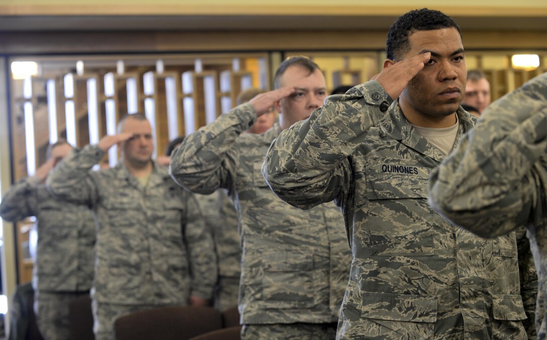 Airmen salute as Taps plays during Master Sgt. Scott W. Scovell’s memorial service inside the Freedom Chapel at Ellsworth Air Force Base, S.D., Jan. 11, 2017. Scovell passed away Jan. 3, and is survived by his wife and two children. (U.S. Air Force photo by Airman 1st Class Denise M. Jenson)