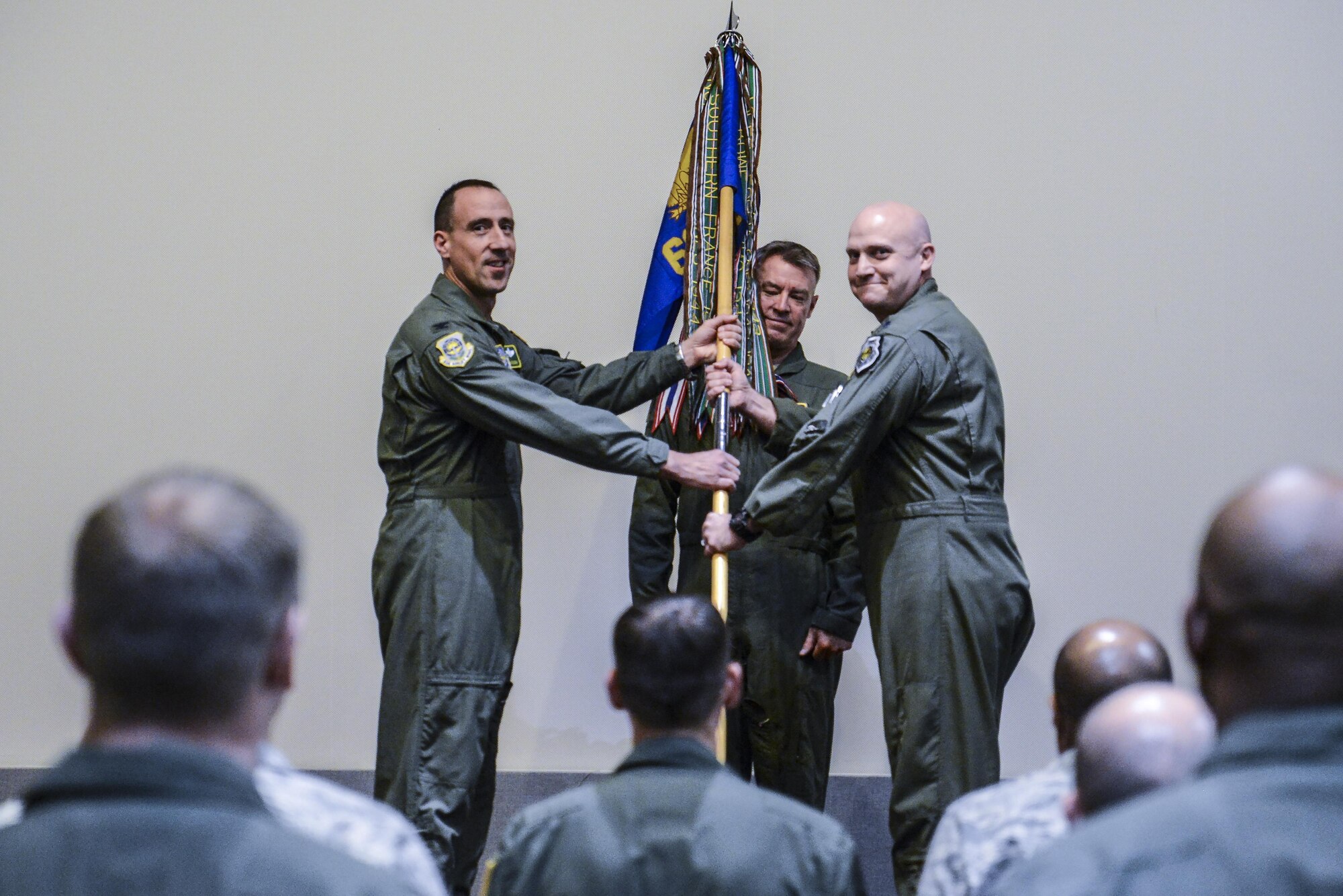 Col. Leonard Kosinski, 62nd Airlift Wing commander, presents the 62nd Operations Group guidon to Lt. Col. Brian Smith, incoming 62nd OG commander during a ceremony Jan. 6, 2017, at Joint Base Lewis-McChord, Wash. The passing of the guidon is a military tradition signifying the official assumption of command.