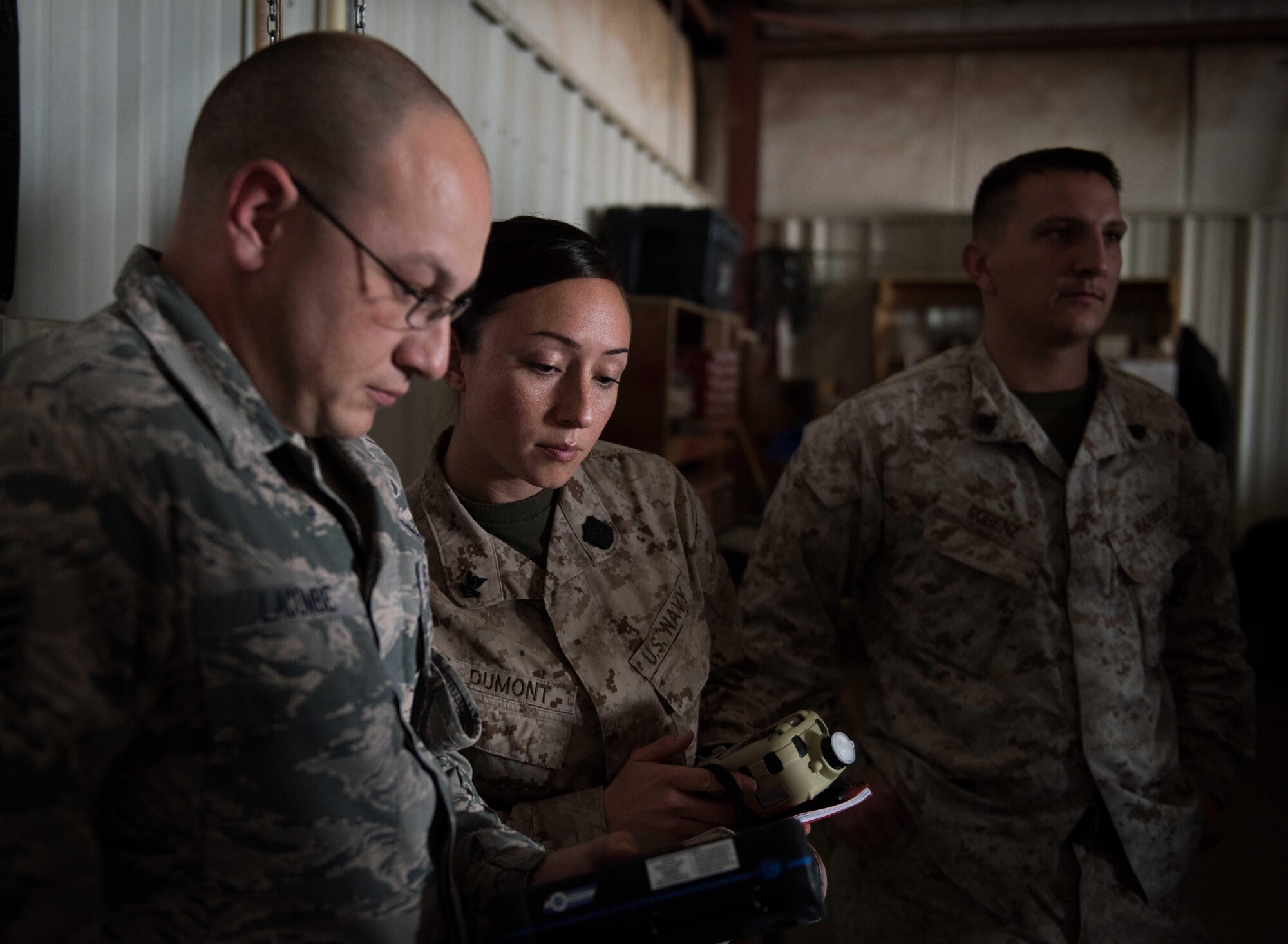 U.S. Air Force Tech. Sgt. Tomas Mata and Staff Sgt. Anthony LaCombe, 332nd Expeditionary Medical Group bioenvironmental engineering specialists, perform a work site assessment at a Marine Corps vehicle maintenance garage at the 407th Air Expeditionary Group, Jan. 5, 2016. The bioenvironmental specialists perform work site safety inspections for physical health hazards to ensure service members are safe. (U.S. Air Force photo by Staff Sgt. R. Alex Durbin)