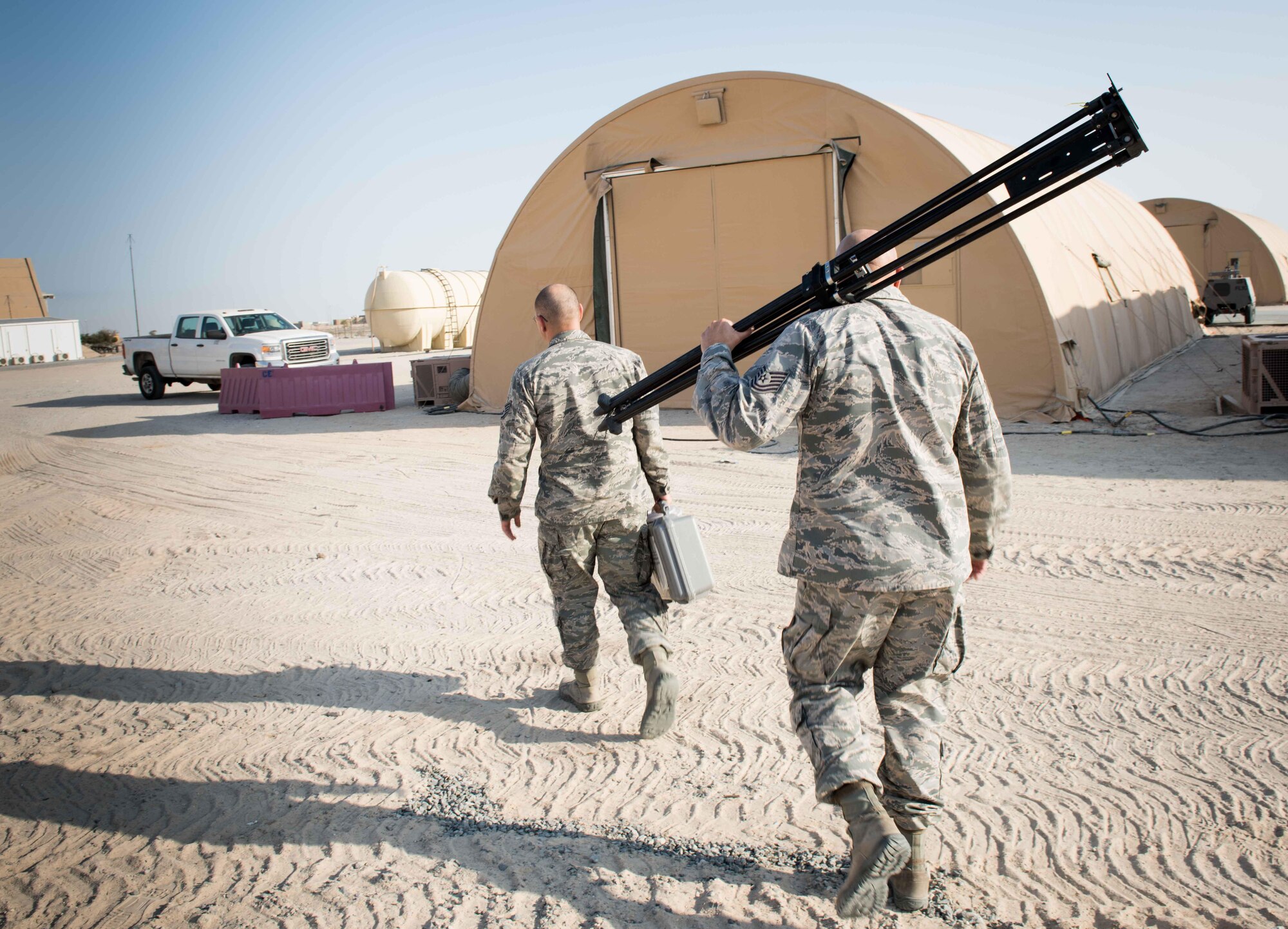 U.S. Air Force Tech. Sgt. Tomas Mata and Staff Sgt. Anthony LaCombe, 332nd Expeditionary Medical Group bioenvironmental engineering specialists, perform a work site assessment at a Marine Corps vehicle maintenance garage at the 407th Air Expeditionary Group, Jan. 5, 2016. The bioenvironmental specialists perform work site safety inspections for physical health hazards to ensure service members are safe. (U.S. Air Force photo by Staff Sgt. R. Alex Durbin)