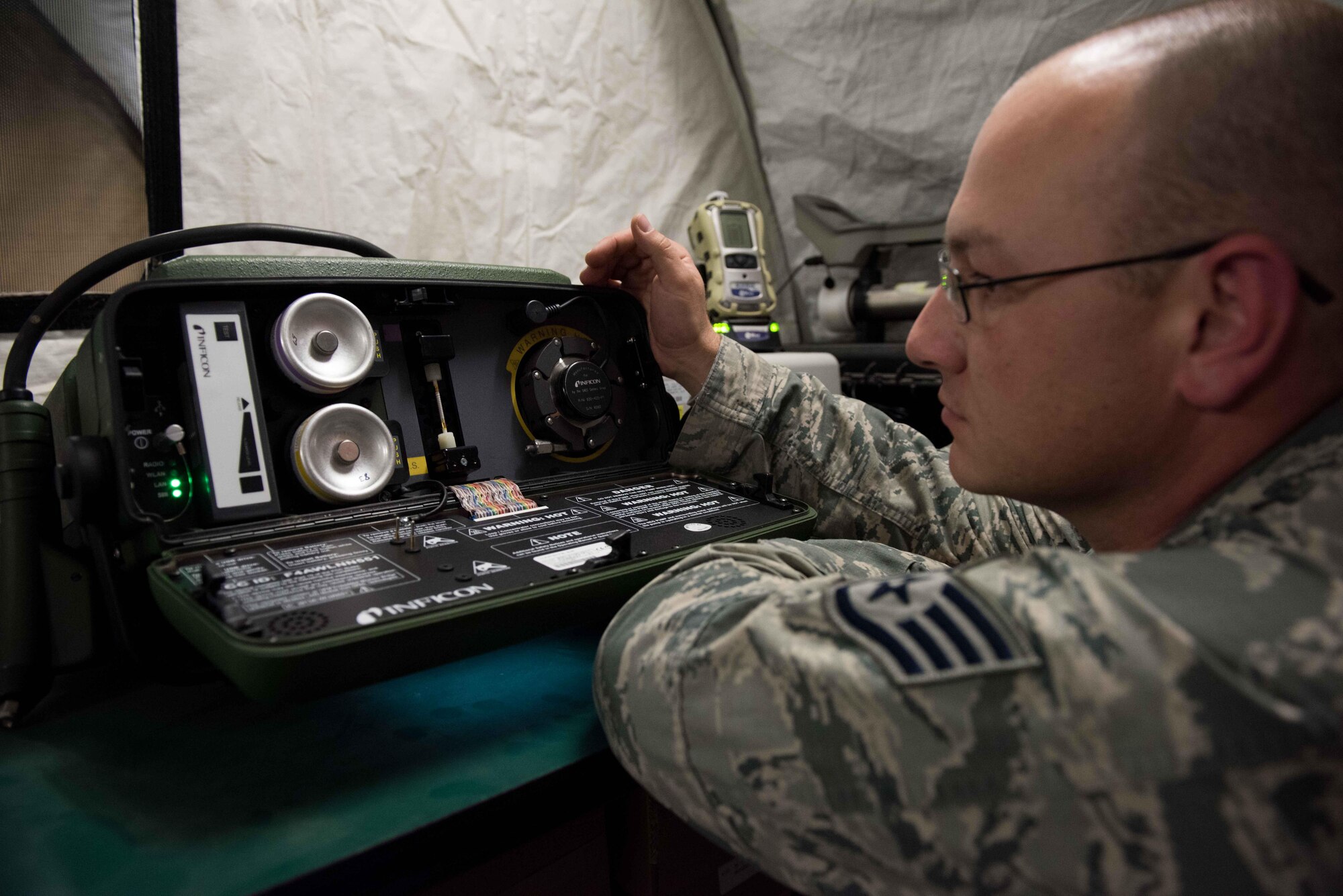 U.S. Air Force Tech. Sgt. Tomas Mata and Staff Sgt. Anthony LaCombe, 332nd Expeditionary Medical Group bioenvironmental engineering specialists, perform a work site assessment at a Marine Corps vehicle maintenance garage at the 407th Air Expeditionary Group, Jan. 5, 2016. The bioenvironmental specialists perform work site safety inspections for physical health hazards to ensure service members are safe. (U.S. Air Force photo by Staff Sgt. R. Alex Durbin)