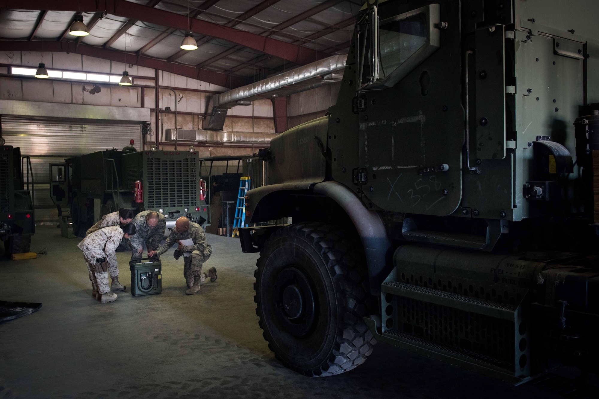 U.S. Air Force Tech. Sgt. Tomas Mata and Staff Sgt. Anthony LaCombe, 332nd Expeditionary Medical Group bioenvironmental engineering specialists, perform a work site assessment at a Marine Corps vehicle maintenance garage at the 407th Air Expeditionary Group, Jan. 5, 2016. The bioenvironmental specialists perform work site safety inspections for physical health hazards to ensure service members are safe. (U.S. Air Force photo by Staff Sgt. R. Alex Durbin)