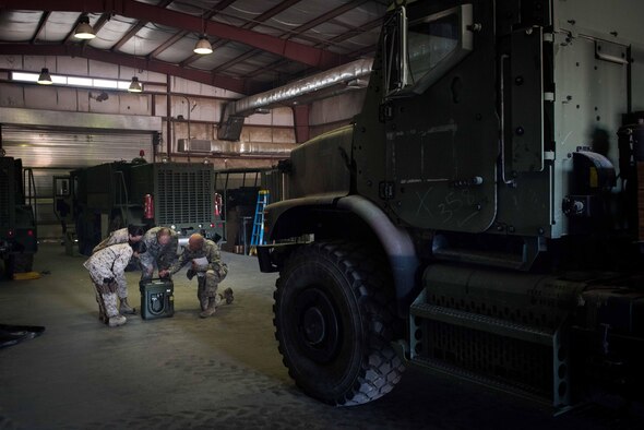 U.S. Air Force Tech. Sgt. Tomas Mata and Staff Sgt. Anthony LaCombe, 332nd Expeditionary Medical Group bioenvironmental engineering specialists, perform a work site assessment at a Marine Corps vehicle maintenance garage at the 407th Air Expeditionary Group, Jan. 5, 2016. The bioenvironmental specialists perform work site safety inspections for physical health hazards to ensure service members are safe. (U.S. Air Force photo by Staff Sgt. R. Alex Durbin)