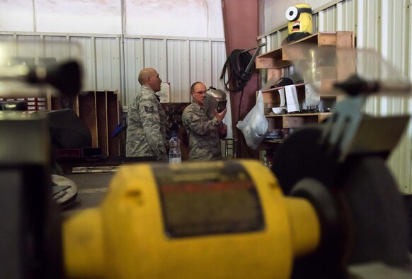 U.S. Air Force Tech. Sgt. Tomas Mata and Staff Sgt. Anthony LaCombe, 332nd Expeditionary Medical Group bioenvironmental engineering specialists, perform a work site assessment at a Marine Corps vehicle maintenance garage at the 407th Air Expeditionary Group, Jan. 5, 2016. The bioenvironmental specialists perform work site safety inspections for physical health hazards to ensure service members are safe. (U.S. Air Force photo by Staff Sgt. R. Alex Durbin)