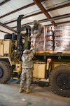 Members of the Louisiana National Guard's 1086th Transportation Company, and Pfc. Mason Madrigal, a Bunkie, Louisiana native, secure pallets of bottled water on a palletized load system vehicle to be delivered to the town of St. Joseph, Jan. 5, 2017. The LANG received the mission to deliver water after Gov. John Bel Edwards declared a public health emergency due to elevated levels of lead and copper in the water.