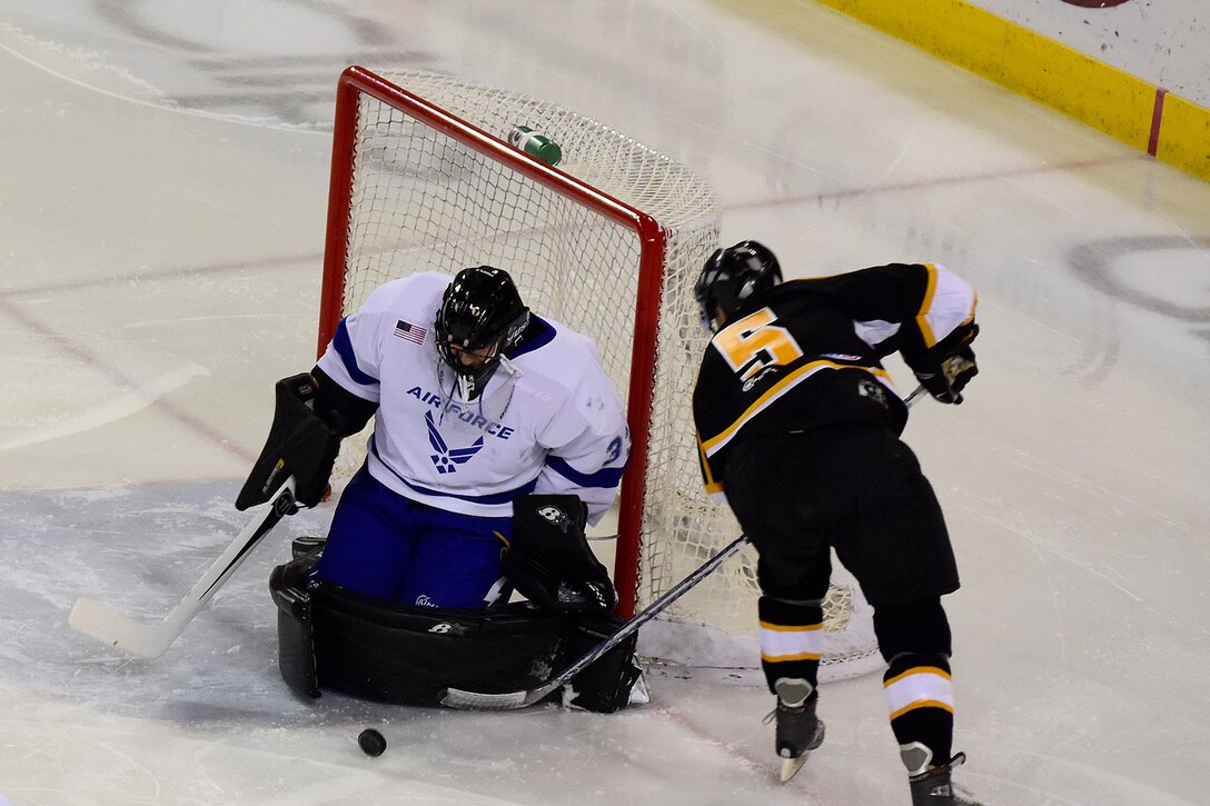 Air Force goalie Senior Airman Stanislav Barilov blocks a point-blank shot on goal from Army Capt. Todd Graham during the second period during the 4th Annual Army vs. Air Force Hockey game at the Sullivan Arena in Anchorage, Alaska, Jan. 7, 2017. Army photo by John Pennell