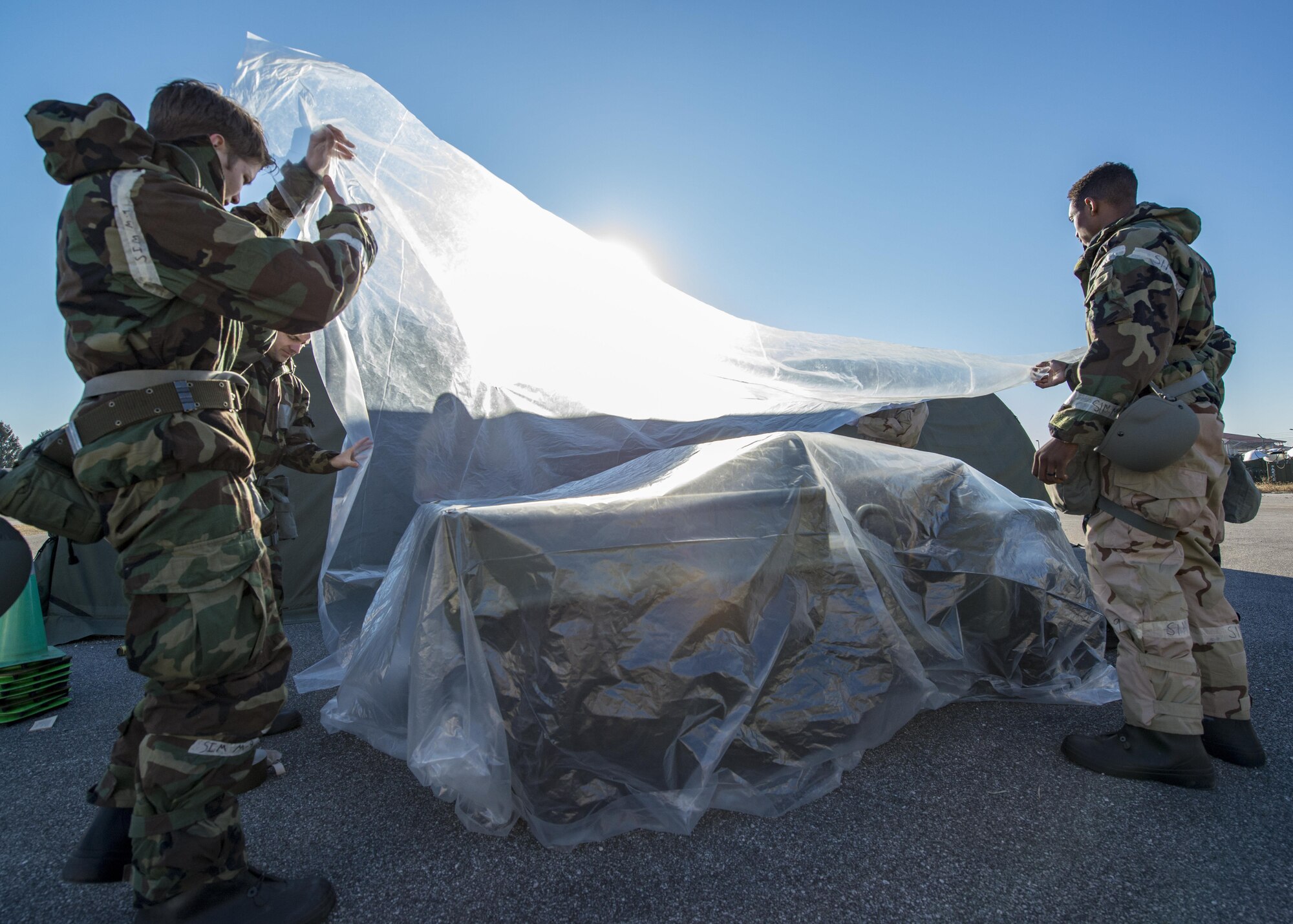 Airmen from the 31st Maintenance Group practice covering and labeling equipment that was simulated contaminated by a hazardous substance during an Expeditionary Skills Rodeo event at Aviano Air Base, Italy on Jan. 6, 2017. The exercise was part of a larger Expeditionary Skills Rodeo which condensed 16 hours of training into 6.6 hours. (U.S. Air Force photo by Senior Airman Cory W. Bush)