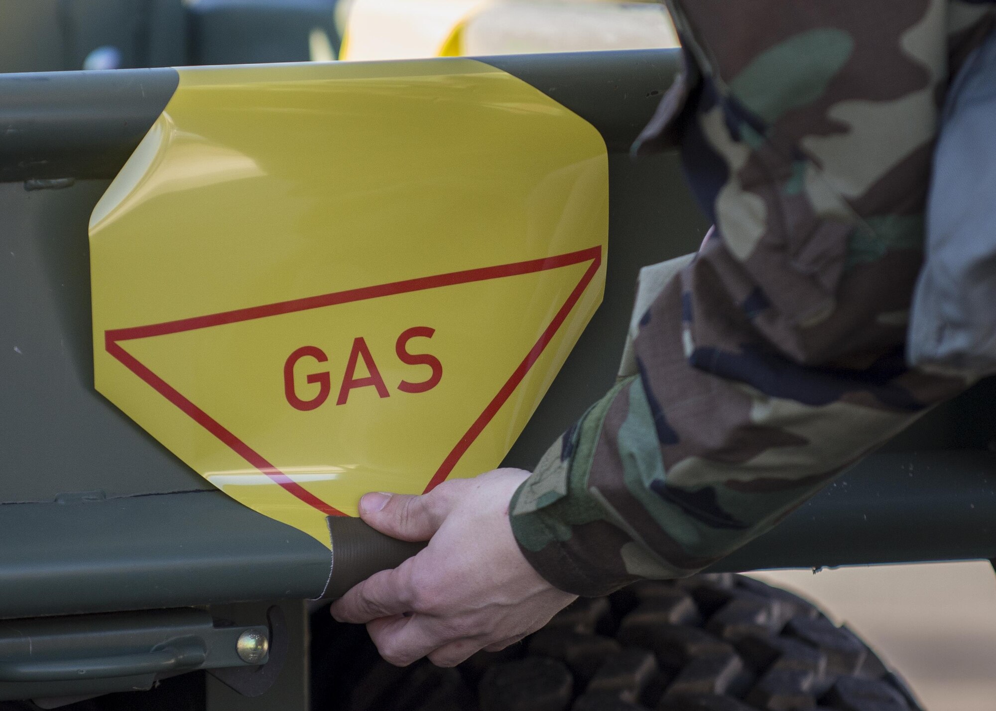An Airman, participating in an Expeditionary Skills Rodeo event, places a sign on a vehicle at Aviano Air Base, Italy on Jan. 6, 2017. During the event, Airmen participated in 12 different courses which certified them for the next three years. (U.S. Air Force photo by Senior Airman Cory W. Bush)