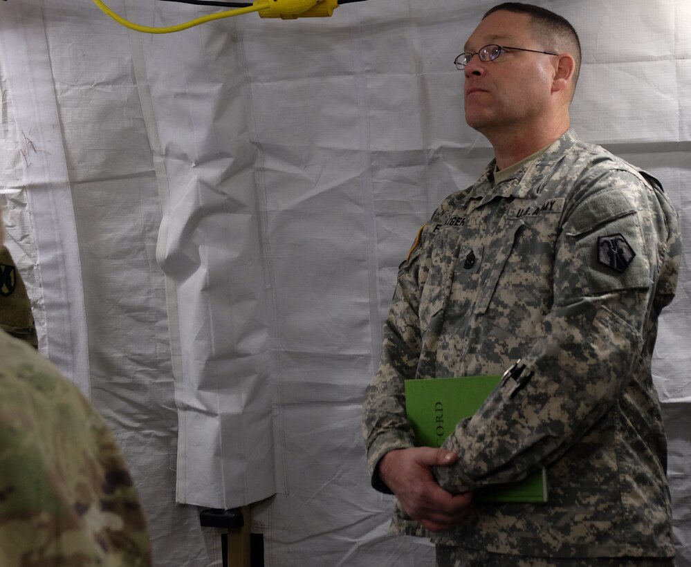 GARLSTEDT, German – Sgt. Maj. Mark Fluckiger, the operations noncommissioned officer in charge from the 7th Mission Support Command, listens during the 21st Theater Sustainment Command commander’s update brief, Jan. 7, 2017. Six Army Reserve Soldiers and two civilians from the 7th MSC are providing logistical and operational support to the 21st TSC’s forward command post during reception staging, onward movement and integration of the 4th Infantry Division’s 3rd Armored Brigade Combat Team as part of U.S. Army Europe’s “Operation Atlantic Resolve,” Jan. 3-23.