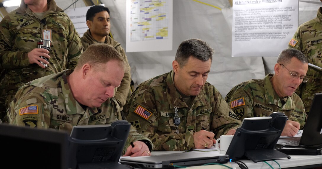 GARLSTEDT, Germany – Left to right, Commanding General Maj. Gen. Duane A. Gamble, 21st Theater Sustainment Command, Col. Jeffrey Knight, chief of operations, 21st TSC, and Brig. Gen. Steven W. Ainsworth, commanding general, 7th Mission Support Command, listen during the 21st TSC commander’s update brief, Jan. 7, 2017. Six Army Reserve Soldiers and two civilians from the 7th Mission Support Command are providing logistical and operational support to the 21st Theater Sustainment Command’s forward command post during reception staging, onward movement and integration of the 4th Infantry Division’s 3rd Armored Brigade Combat Team as part of U.S. Army Europe’s “Operation Atlantic Resolve,” Jan. 3-23.