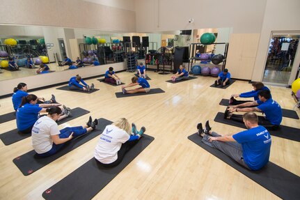 A group of volunteers and wounded warriors stretch before exercising on a rowing machine during the week-long Air Force Wounded Warrior (AFW2) Warrior CARE event at Joint Base San Antonio-Randolph Jan. 10, 2017. The goal of the AFW2 Warrior CARE program is to provide wellness events for seriously wounded, ill and injured military members, veterans and their caregivers. (U.S. Air Force photo by Airman 1st Class Lauren Parsons/Released)