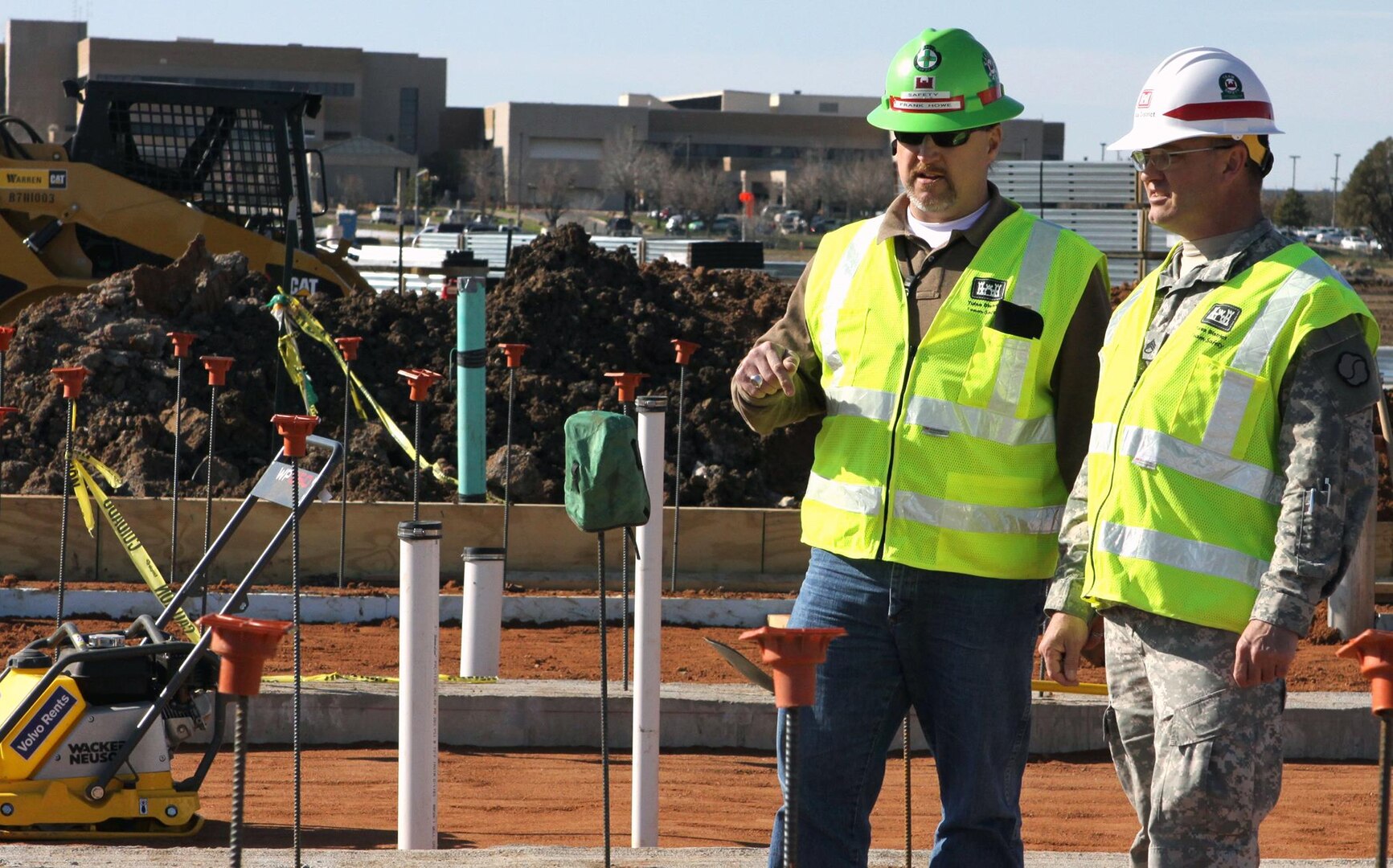 Frank Howe (left), safety representative for the U.S. Army Corps of Engineers, talks with Army Staff Sgt. Louis Thompson about identifying hazardous situations on job sites at Fort Sill, Okla. Thompson, a Soldier in Fort Sill's Warrior Transition battalion, is getting on-the-job experience through Operation Warfighter.