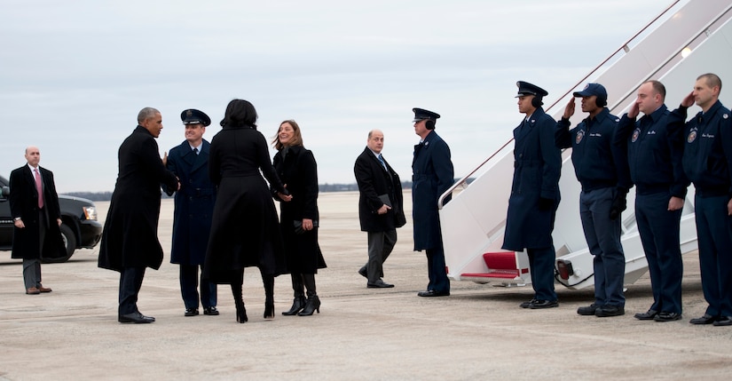 President Barack Obama and first lady, Michelle Obama, greet Col. Christopher Thompson, 89th Airlift Wing vice commander, and his wife, Shannon, at Joint Base Andrews, Md., Jan. 10, 2017. The 89th AW provides global special air mission airlift, logistics, aerial port and communications for the president, first lady, vice president and cabinet members to ensure their air transportation to and from JBA is comfortable, reliable and protected. (U.S. Air Force photo by Staff Sgt. Joe Yanik)