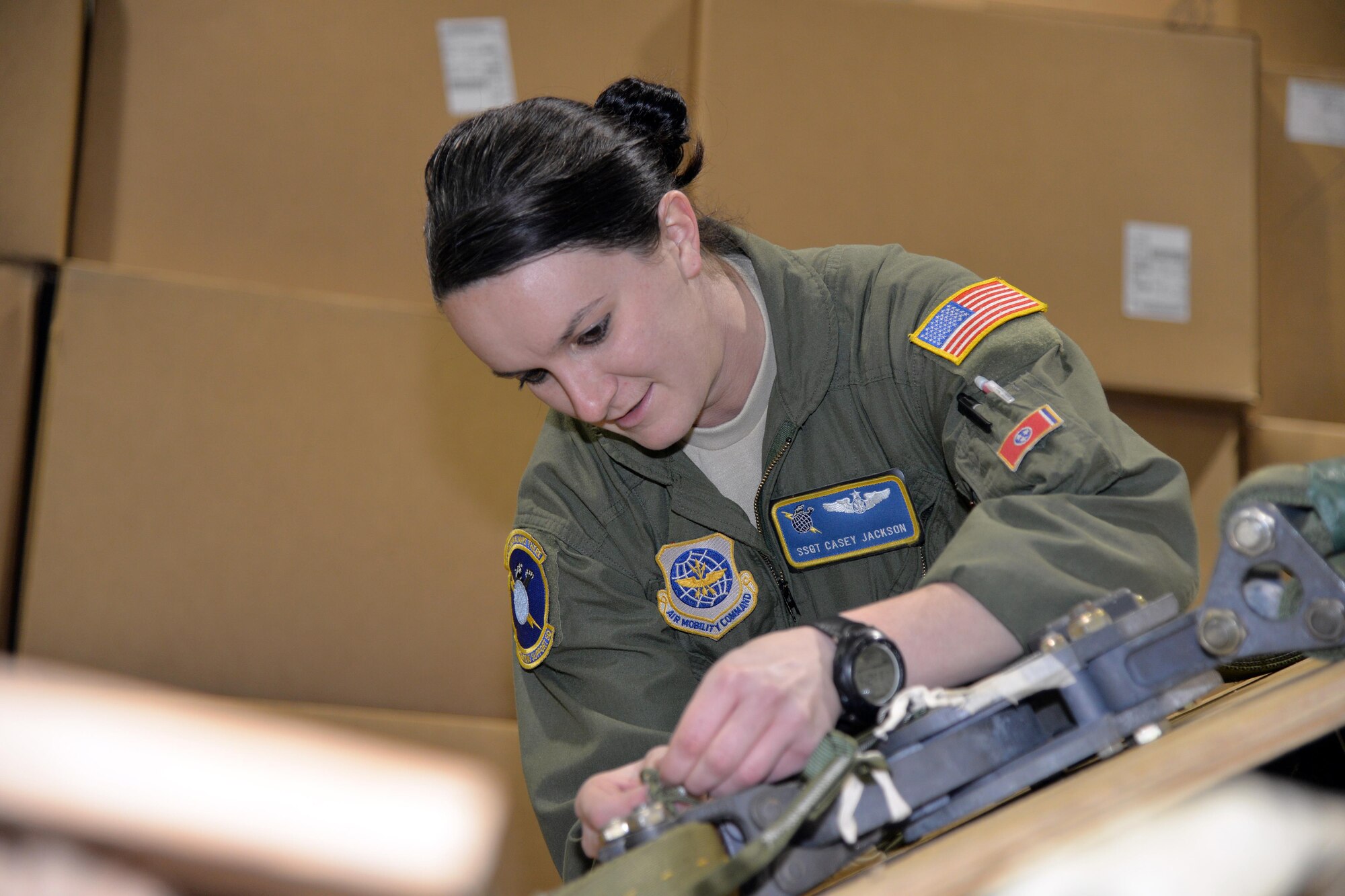 Staff Sgt. Casey Jackson, 43rd Operations Support Squadron Joint Airdrop Inspector, inspects an M2 release on a parachute rigged to a Humvee during a Deployment Readiness Exercise on Pope Army Airfield, North Carolina, Jan. 6, 2017. The DRE exercises the 43rd Air Mobility Operation Group's outload processes in order to get the Global Response Force deployed quickly and safely. The M2 release disengages the parachute from the load upon landing to prevent the parachute from dragging the load across the ground. Joint Airdrop Inspectors make sure that each load is in compliance with Air Force regulations before being loaded onto aircraft. (U.S. Air Force photo by Master Sgt. Thomas J. Doscher/Released)