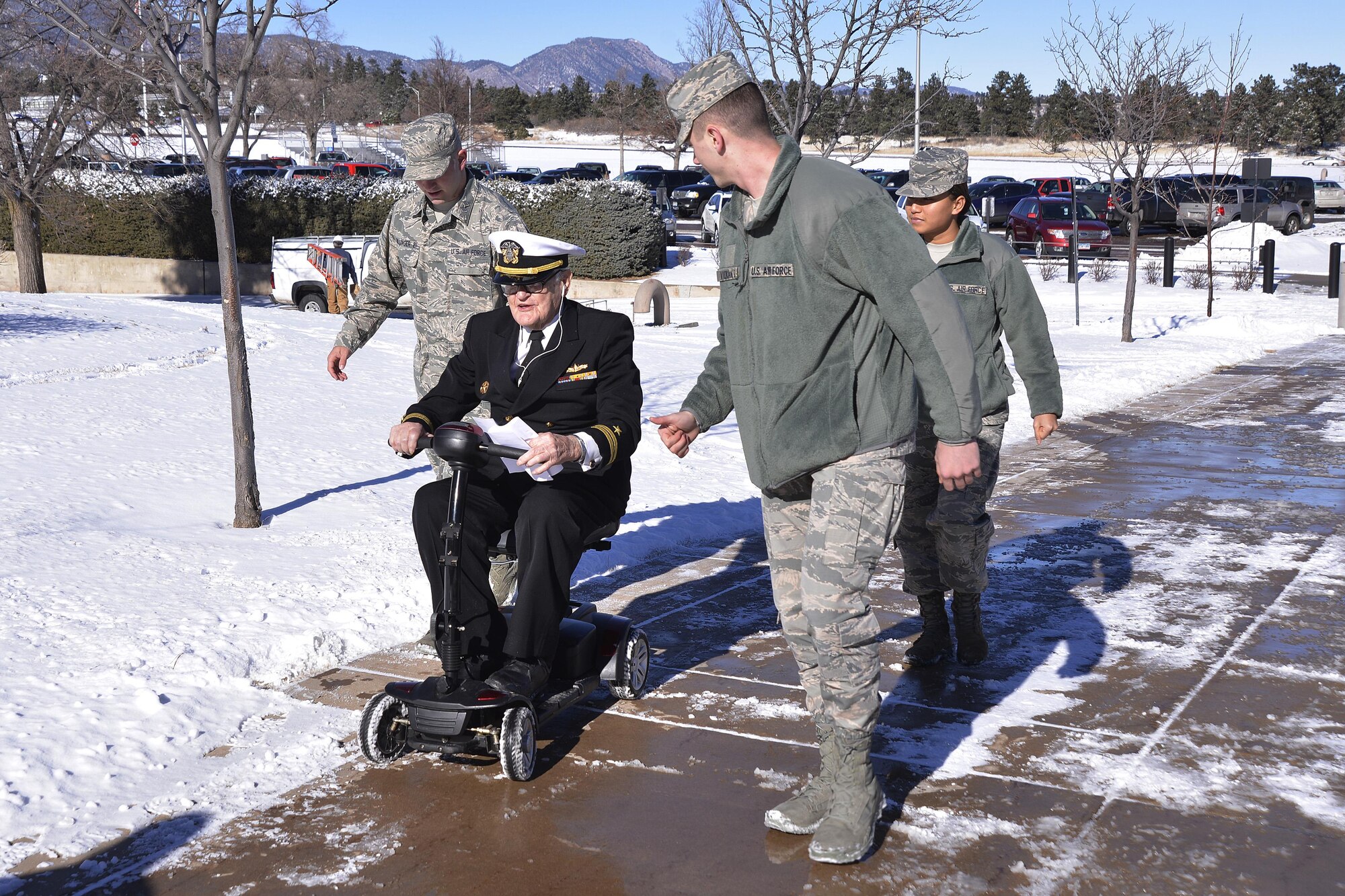 Retired Navy Lt. Jim Downing is escorted by cadet candidates across the U.S. Air Force Academy Preparatory School, Jan. 6, 2017 at the U.S. Air Force Academy. Downing visited the Prep School to share his story of surviving the Dec. 7, 1941 attack on Pearl Harbor by the Imperial Japanese. Downing, 103, is the second oldest-known survivor of the attack. (U.S. Air Force photo/Jason Gutierrez)