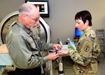 U.S. Army Institute of Surgical Research Senior Scientist, Victor “Vic” Convertino, Ph.D., demonstrates the functions and capabilities of the Compensatory Reserve Index to Maj. Gen. Barbara Holcomb, Commanding General, U.S. Army Medical Research and Material Command.