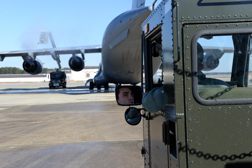 Airman 1st Class Gerard Tembrock, 43rd Air Mobility Squadron porter, waits in a K Loader while members of the 43rd AMS finish de-icing a C-17 Globemaster III on the Pope Army Airfield flightline Jan. 8, 2017. The 43rd Air Mobility Operations Group is responsible for loading cargo and passengers and maintaining transient aircraft operating out of Pope AAF. (U.S. Air Force photo by Master Sgt. Thomas J. Doscher/released)
