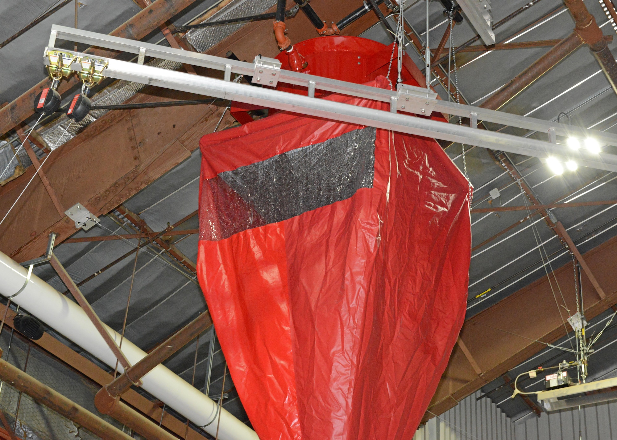 Plastic windows were installed in each funnel so the fire department can see the flow of water from the fire suppression dispenser. The recommendation came from the fire department after they tested a prototype in May 2016. The funnels are lightweight and can be lifted or carried by one person. (U.S. Air Force photos by Kenji Thuloweit) 