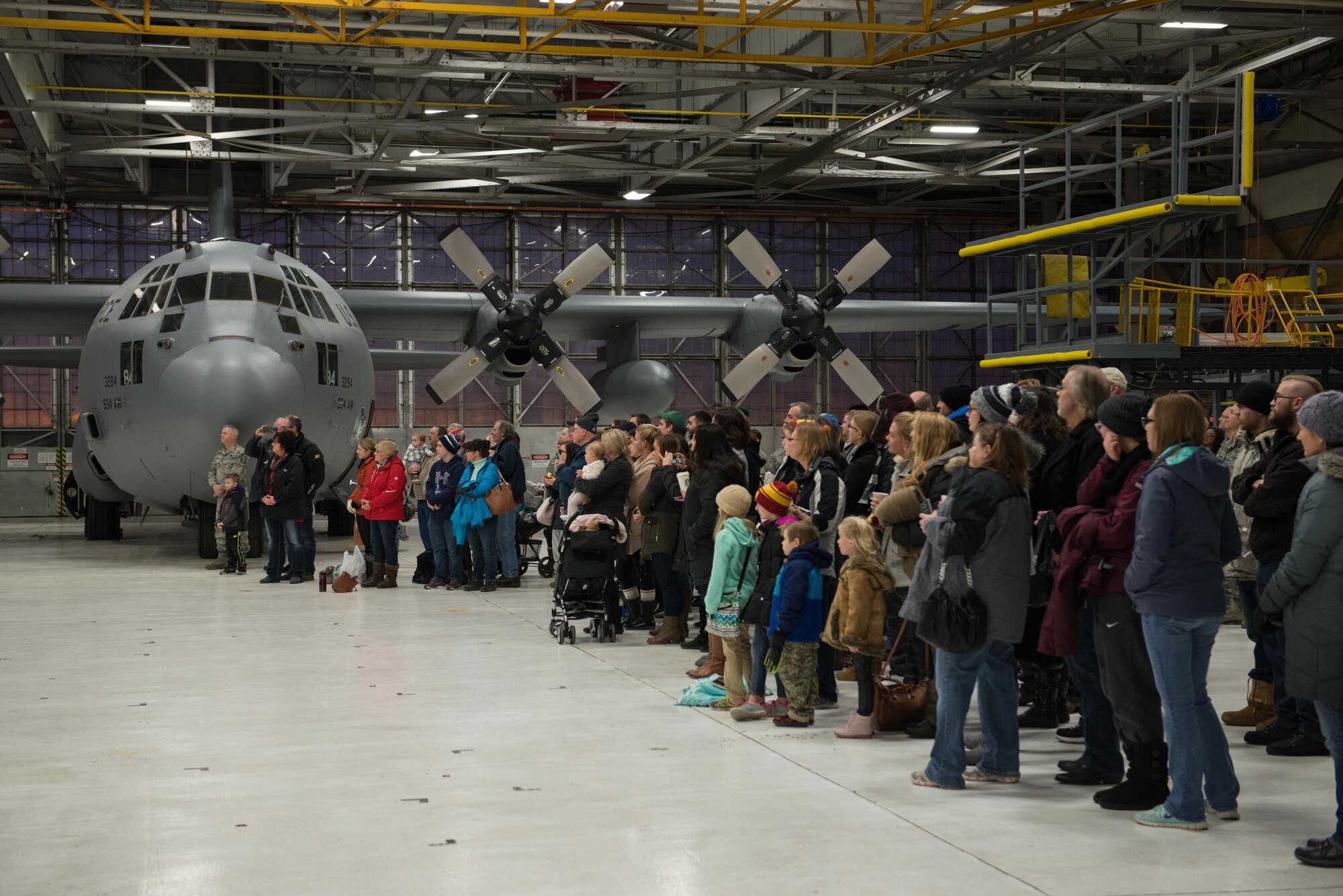 Friends and families of deployers gather in the hangar at the 934th Airlift Wing for a ceremony before the Jan. 8 deployment.