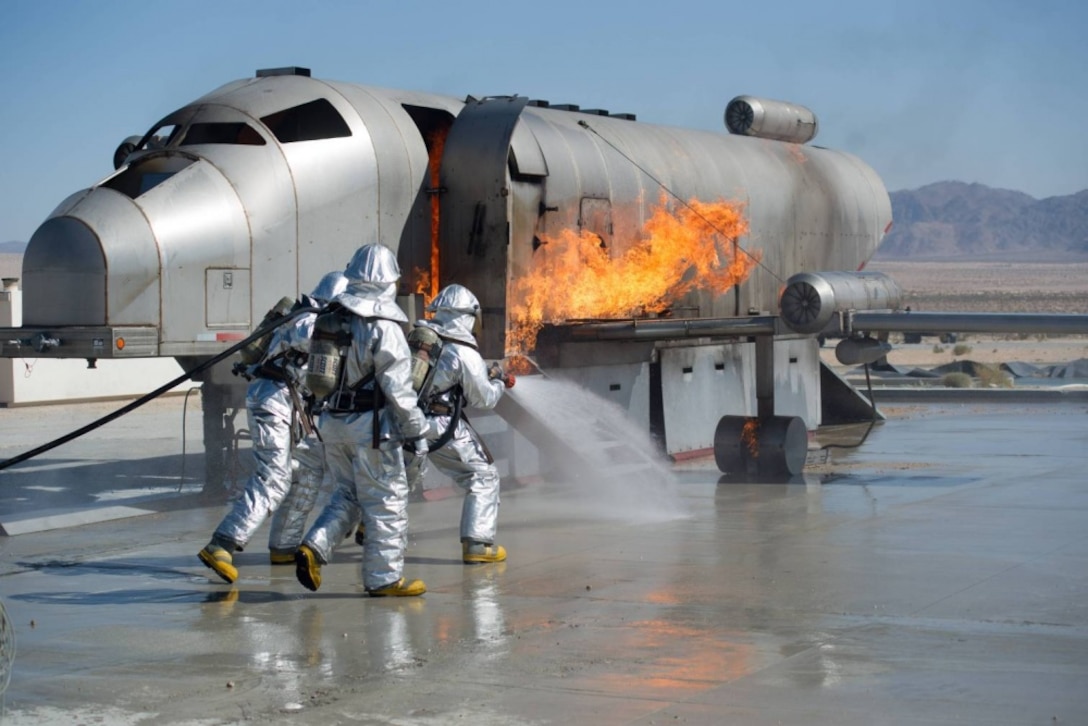 U.S. Marines from Marine Wing Support Squadron 471 Airfield Rescue and Fire Fighting platoon put out a simulated aircraft fire during Integrated Training Exercise 4-14 aboard the Marine Corps Air Ground Combat Center Twentynine Palms, Calif., June 14, 2014. Marines from MWSS 471 are training to be part of a Marine Air Ground Task Force. 