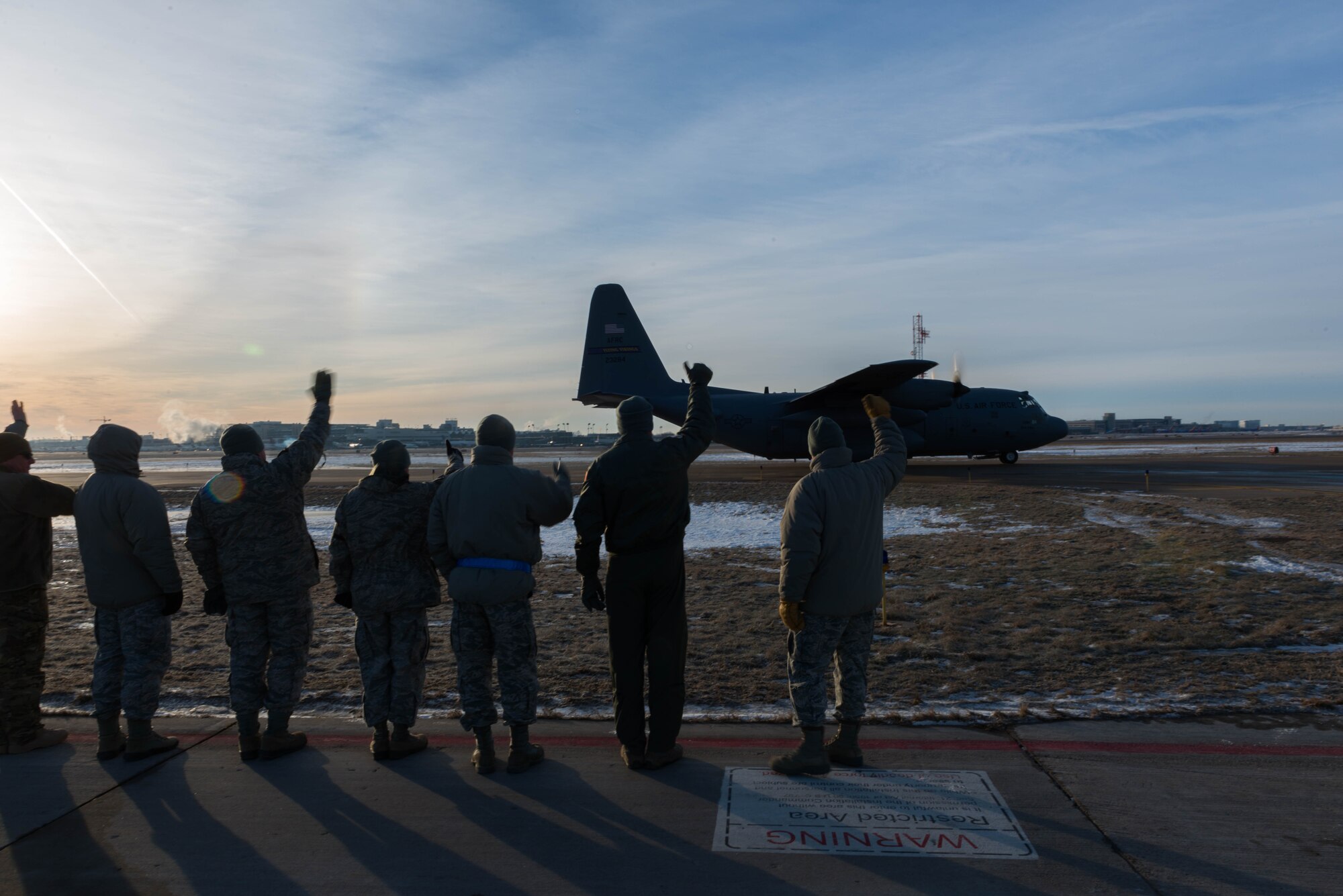 934th Airlift Wing senior leadership waves to a plane as it takes off in support of the deployment to Southwest Asia on January 8. (U.S. Air Force photo by Tech. Sgt. Trevor Saylor)