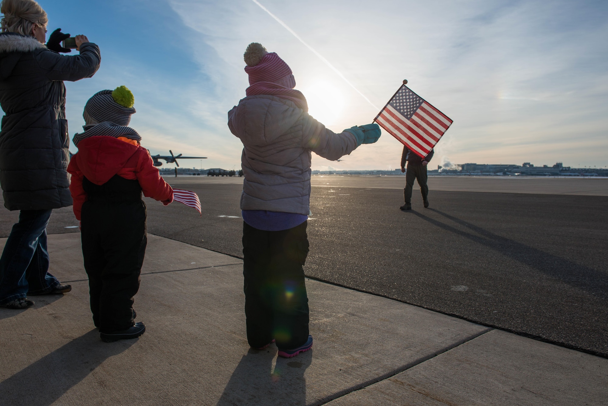 Kyra Dolby and her children, 3 year-old Bauer and 5 year-old Bentley, watch and wave to Kyra's father, Lt. Col. Don Petros as he departs for Southwest Asia on January 8. (U.S. Air Force photo by Tech. Sgt. Trevor Saylor)
