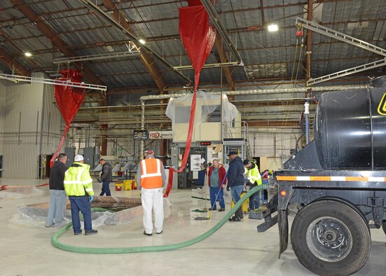 Following the test, the containment pools were drained by contract workers with hoses into a tanker truck. (U.S. Air Force photo by Kenji Thuloweit)