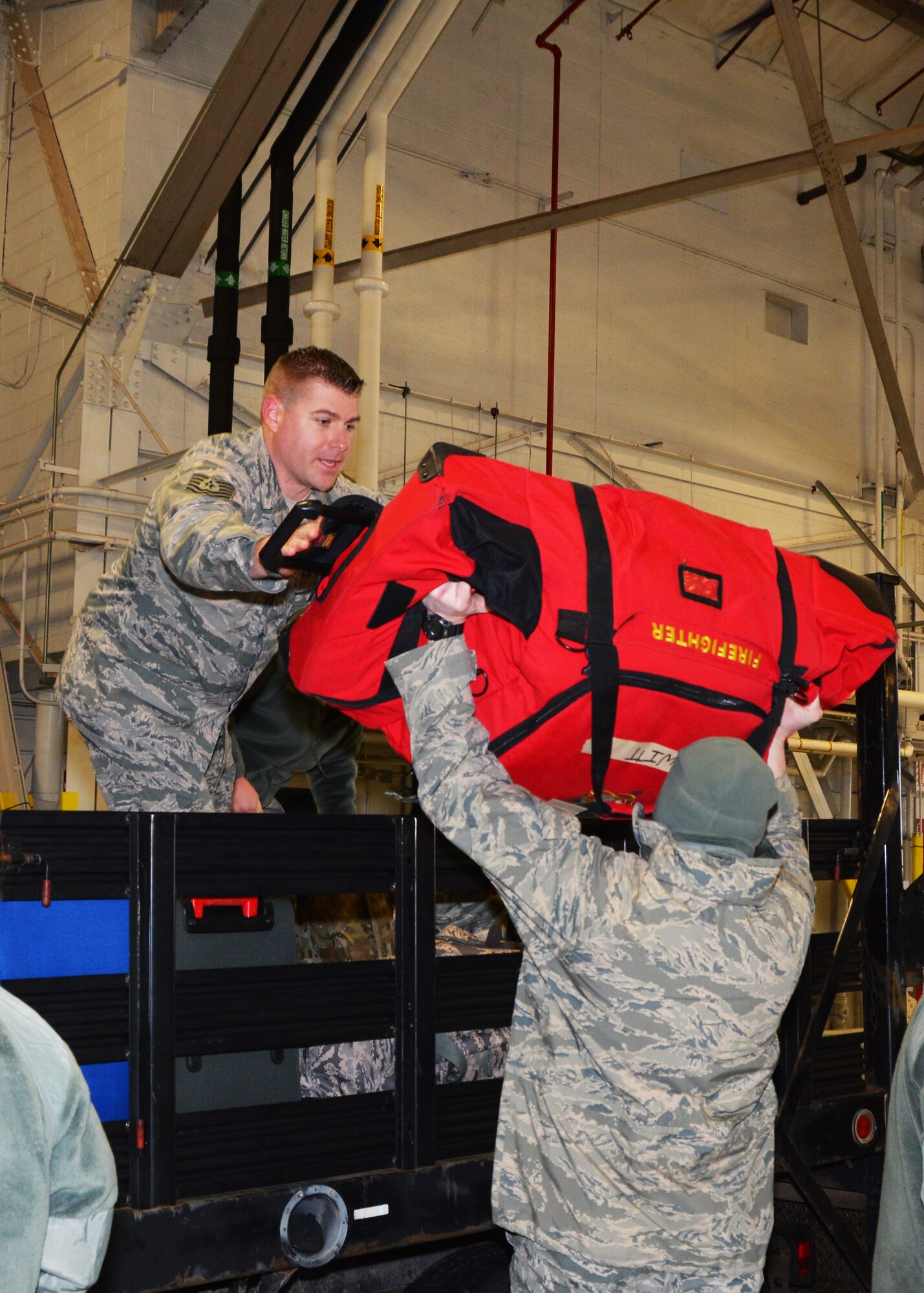 Tech. Sgt. Kevin Giles of the 507th Security Forces Squadron stacks personal deployment bags on a truck in preparation for an exercise processing the mobility processing line Jan. 8, 2017, in Hangar 1030 at Tinker Air Force Base, Okla. during a deployment processing line Jan. 8, 2017, at Tinker Air Force Base, Okla. Reservists with the 507th Air Refueling Wing participated in the exercise in preparation for the upcoming nuclear operational readiness inspection in March 2016. (U.S. Air Force photo/Tech Sgt. Lauren Gleason)