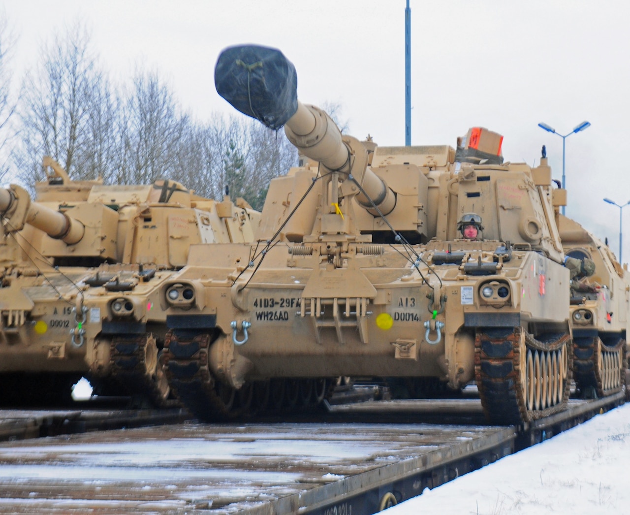 An American soldier from 3rd Battalion, 29th Field Artillery Regiment, 3rd Armored Brigade Combat Team, 4th Infantry Division, drives a M109 Paladin self-propelled howitzer off of a flatcar in Drawsko Pomorskie, Poland, Jan. 9, 2017. The howitzer was one of 53 vehicles that arrived in Northeastern Poland from the Port of Bremerhaven, Germany, as part of Operation Atlantic Resolve. Rotating units through the European theater enhances U.S. European Command’s ability to deter aggression and assure U.S. allies. Army photo by Staff Sgt. Corinna Baltos