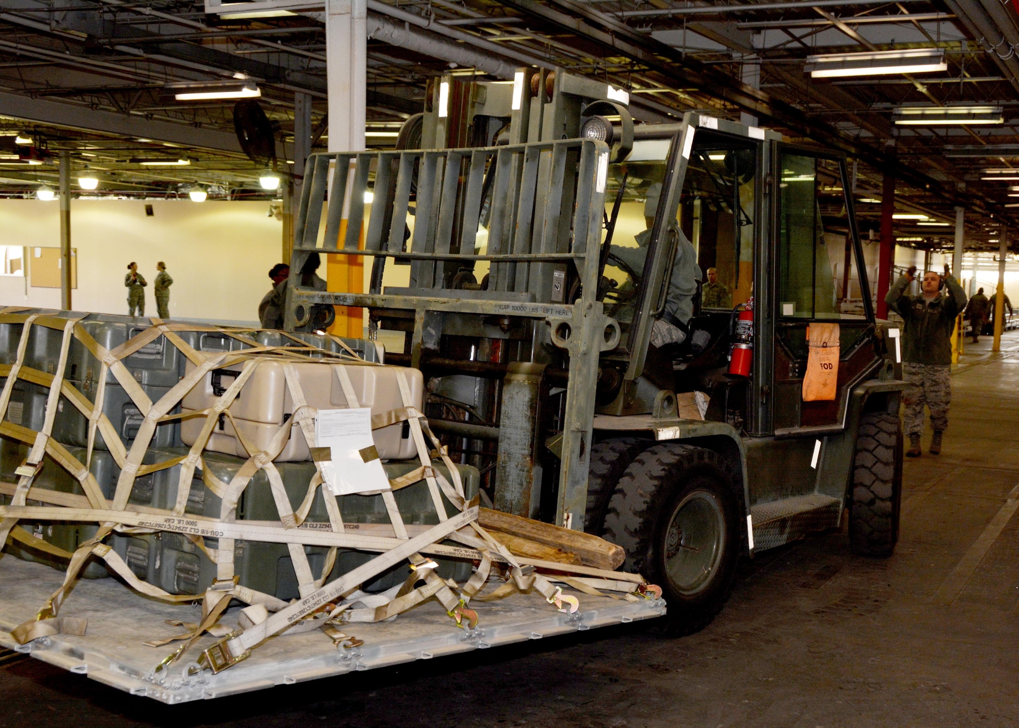 Staff Sgt. Adam Sanders of the 72nd Aerial Port Squadron directs a 10K forklift in preparation for a deployment exercise Jan. 8, 2017, at Tinker Air Force Base, Okla. Reservists with the 507th Air Refueling Wing participated in the exercise in preparation for the upcoming nuclear operational readiness inspection in March 2016. (U.S. Air Force photo/Tech Sgt. Lauren Gleason)