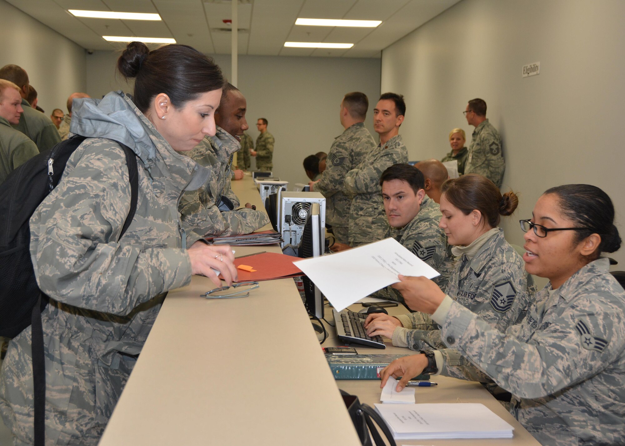 Master Sgt. Tracy Lancaster of the 507th Air Refueling Wing command post hands her medical paperwork to Senior Airman Ashley Davis-Reyes, Medical technician with the 507th Medical Squadron, during an exercise deployment processing line Jan. 8, 2017, at Tinker Air Force Base, Okla. Reservists with the 507th Air Refueling Wing participated in the exercise in preparation for the upcoming nuclear operational readiness inspection in March 2016. (U.S. Air Force photo/Tech Sgt. Lauren Gleason)