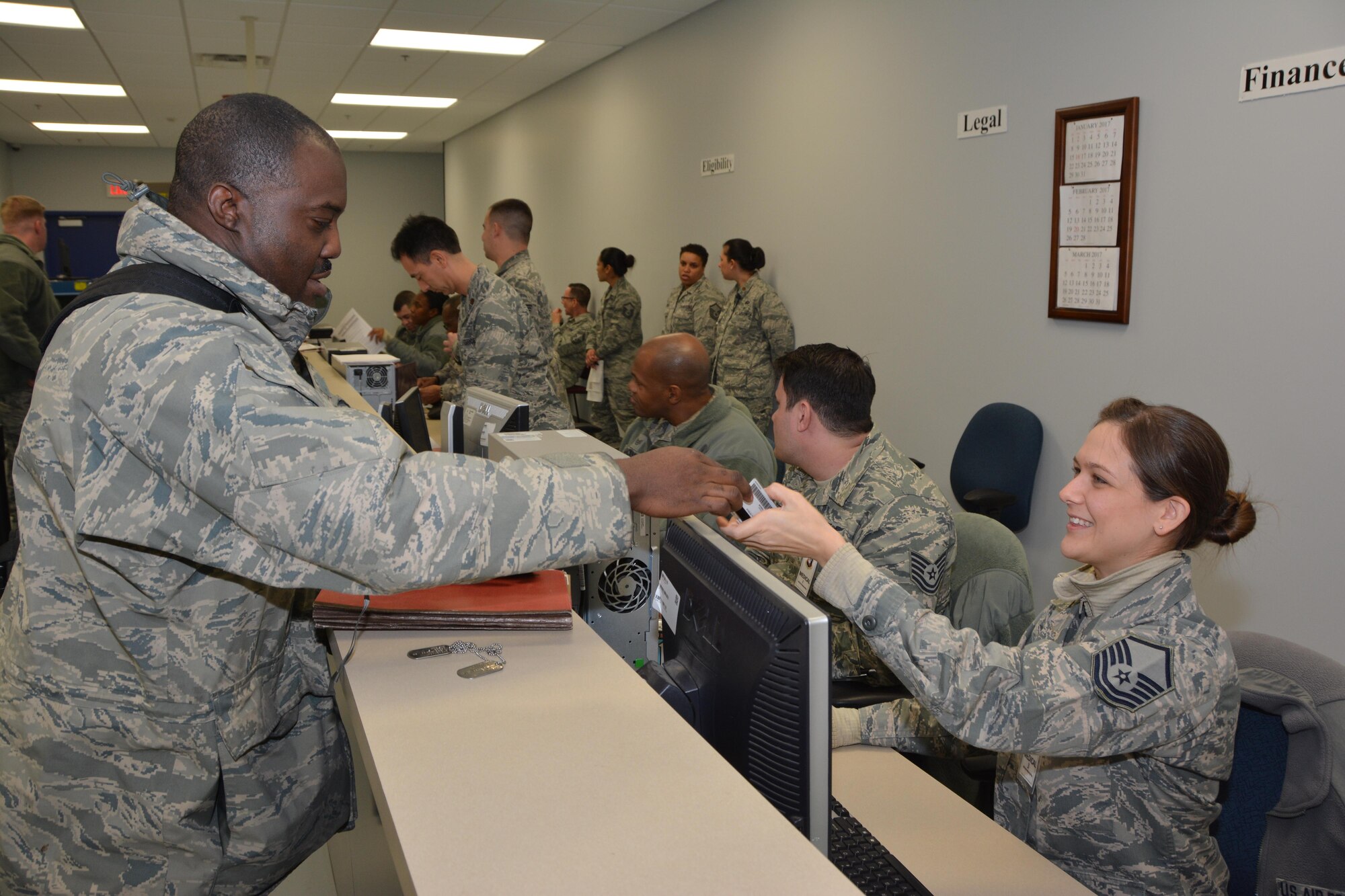Master Sgt. Aubrie Miskell, medical technician with the 507th Medical Squadron, helps Tech. Sgt. Derek Wilson of the 507th Force Support Squadron process the mobility processing line Jan. 8, 2017, at Tinker Air Force Base, Okla. Reservists with the 507th Air Refueling Wing participated in the exercise in preparation for the upcoming nuclear operational readiness inspection in March 2016. (U.S. Air Force photo/Tech Sgt. Lauren Gleason)