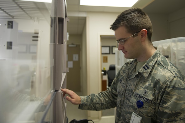 Capt. Kristofer Yaple, chief of pharmacy services for the 1st Special Operations Medical Support Squadron, searches a computer for a prescription at Hurlburt Field, Fla., Jan. 10, 2017. Pharmacists are responsible for dispensing prescribed medications and helping patients understand proper usage and side effects. The nation annually observes Jan. 12 as National Pharmacist Day. (U.S. Air Force photo by Airman 1st Class Joseph Pick)