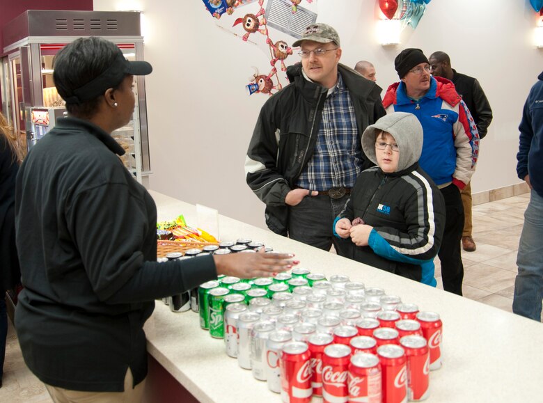 Master Sgt. Robert Bedwell, Air National Guard Bureau Command Post training and standardization manager, and his son, Connor, place an order with Shavown Brown, movie theater attendant, at the base movie theater concession area at Joint Base Andrews, Md., Dec. 16, 2016. During the fall of 2016, the theater was renovated with a concession area, audio and visual equipment, bathroom tiling and a heating, ventilation and air conditioning system. (U.S. Air Force photo by Staff Sgt. Joe Yanik)