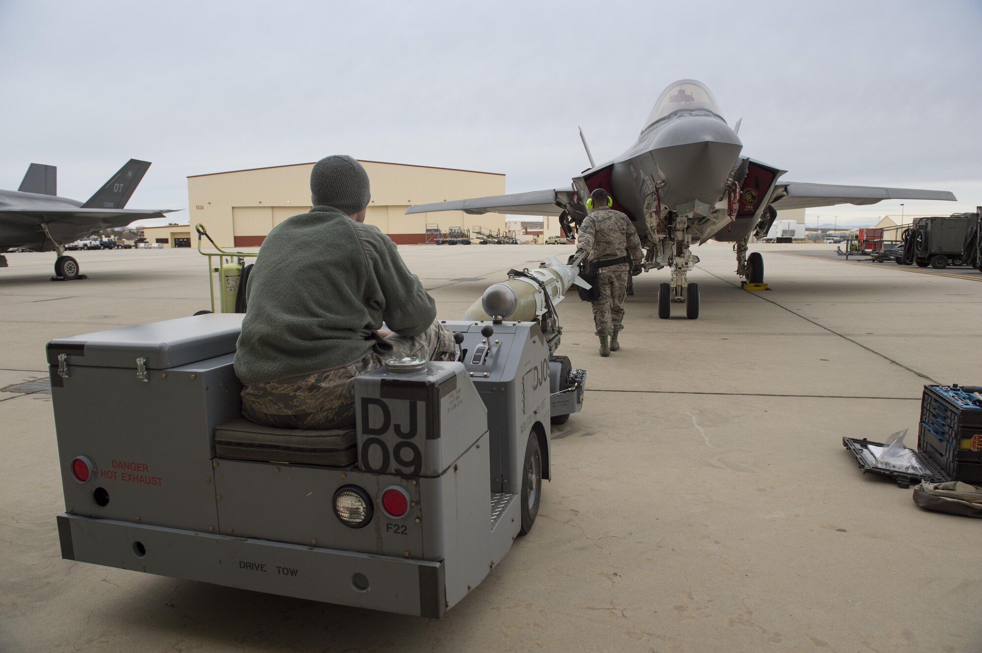 A member of the 461st Aircraft Maintenance Unit - Lightning transports a GBU-31v3 to their assigned F-35 Lightning II Joint Strike Fighter during the 4th Quarter Weapons Load Competition Jan. 3 at Hangar 1600. (U.S. Air Force photo by Joseph Gocong)
