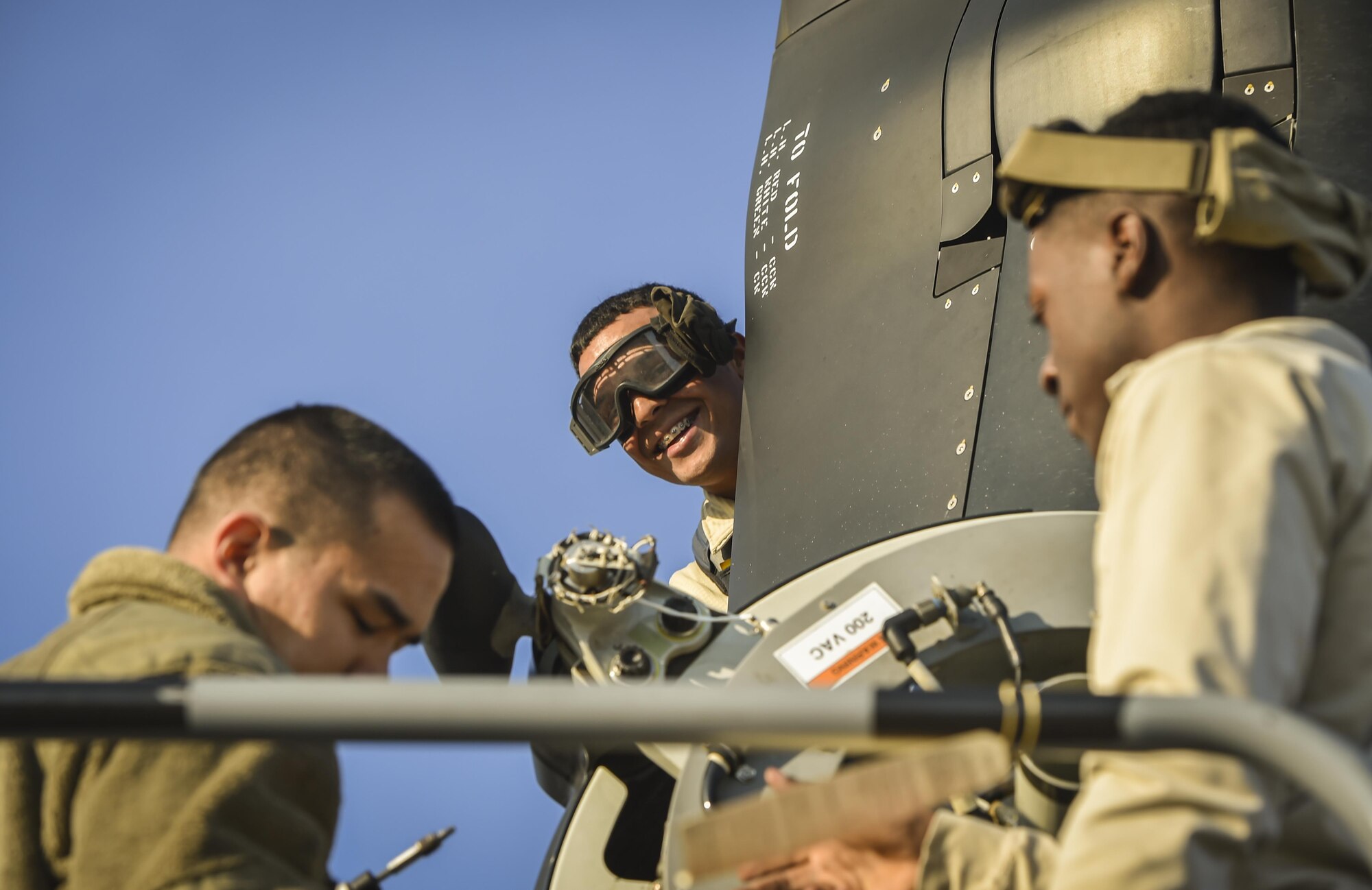 Senior Airman Benjamin Delone, a crew chief with the 801st Special Operations Aircraft Maintenance Squadron, smiles during routine maintenance of a CV-22 Osprey tiltrotor aircraft at Hurlburt Field, Fla., Jan. 9, 2017. The 801st SOAMXS maintenance responsibilities include servicing, phase inspections, troubleshooting, repairs, modifications and launch and recovery of the aircraft. (U.S. Air Force photo by Staff Sgt. Christopher Callaway)