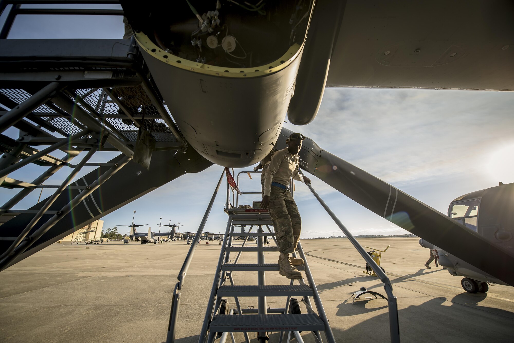 Staff Sgt. Roland Garrett, a crew chief with the 801st Special Operations Aircraft Maintenance Squadron, walks down stairs during routine maintenance of a CV-22 Osprey tiltrotor aircraft at Hurlburt Field, Fla., Jan. 9, 2017. The 801st SOAMXS mission is to perform equipment maintenance in support of global special operations missions. (U.S. Air Force photo by Staff Sgt. Christopher Callaway)
