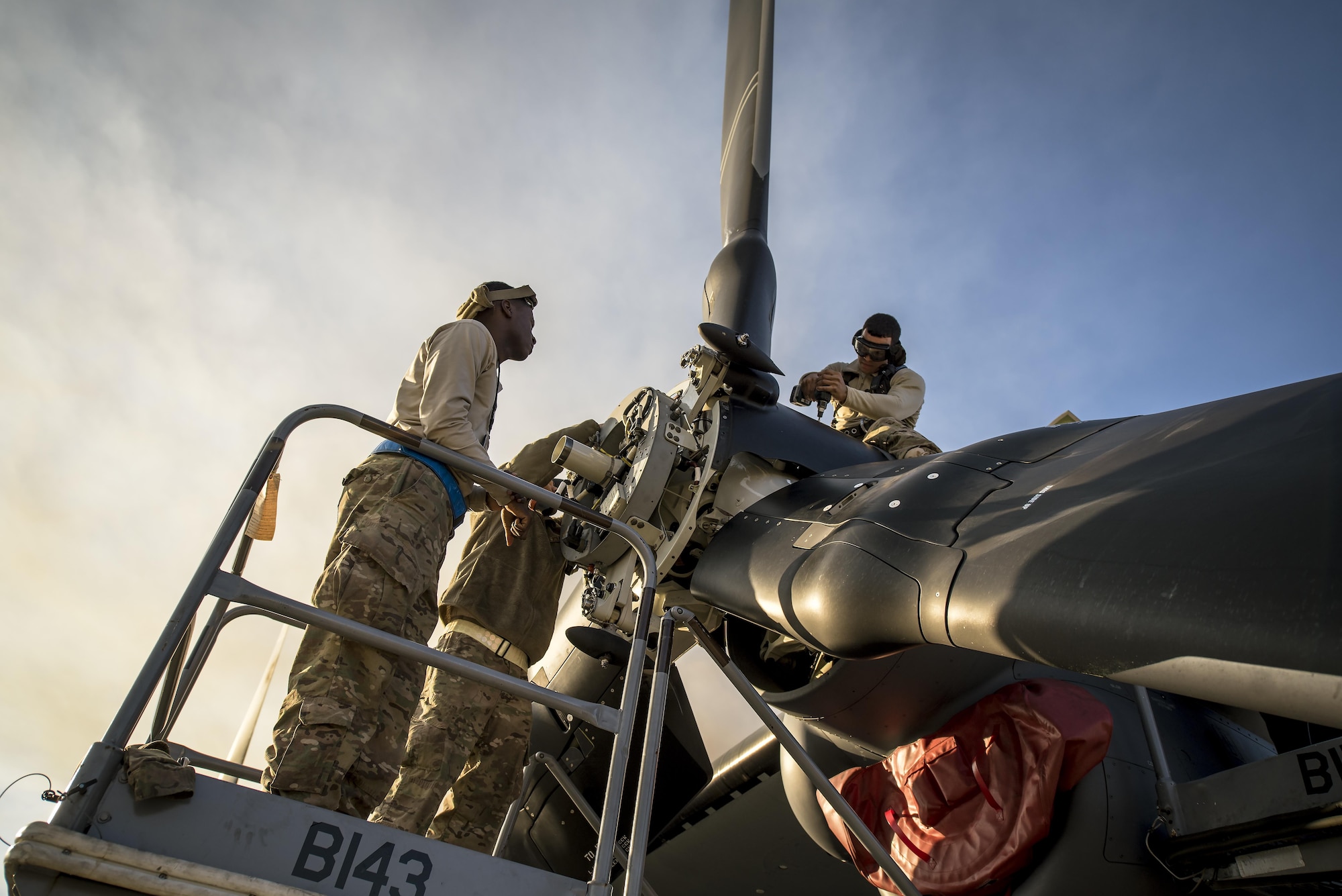 Airmen assigned to the 801st Special Operations Aircraft Maintenance Squadron perform routine maintenance on an engine of a CV-22 Osprey tiltrotor aircraft at Hurlburt Field, Fla., Jan. 9, 2017. The 801st SOAMXS maintenance responsibilities include servicing, phase inspections, troubleshooting, repair, modifications and launch and recovery of the aircraft. (U.S. Air Force photo by Staff Sgt. Christopher Callaway)