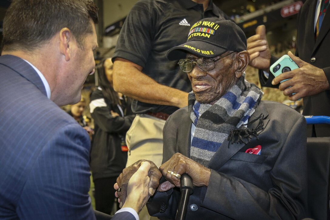 Patrick J. Murphy, undersecretary of the Army, shakes hands with 110-year old Richard Overton, the oldest living World War II veteran, who presented the game ball for the U.S. Army All-American Bowl in San Antonio, Jan. 7, 2017.  The bowl is the nation’s premier high school football game, serving as a launching pad for America’s future college and NFL players. Army Reserve photo by Sgt. 1st Class Brent C. Powell