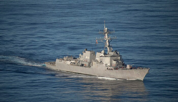 In this file photo, the guided-missile destroyer USS Michael Murphy (DDG 112) maneuvers toward the USNS Amelia Earhart (T-AKE 6) to conduct a vertical replenishment. Murphy is on patrol in the 7th Fleet area of operations supporting security and stability in the Indo-Asia-Pacific.