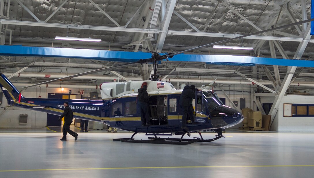 Aircraft mechanics with the 1st Helicopter Squadron prepare a UH-1N Iroquois helicopter for the farewell ceremony of Secretary of the Air Force Deborah Lee James at Joint Base Andrews, Md., Jan. 11, 2017. Planning began approximately three weeks prior to the event and consisted of coordinating with different base agencies to accomplish tasks like transporting distinguished visitors, directing traffic and setting up equipment. (U.S. Air Force photo by Senior Airman Mariah Haddenham)