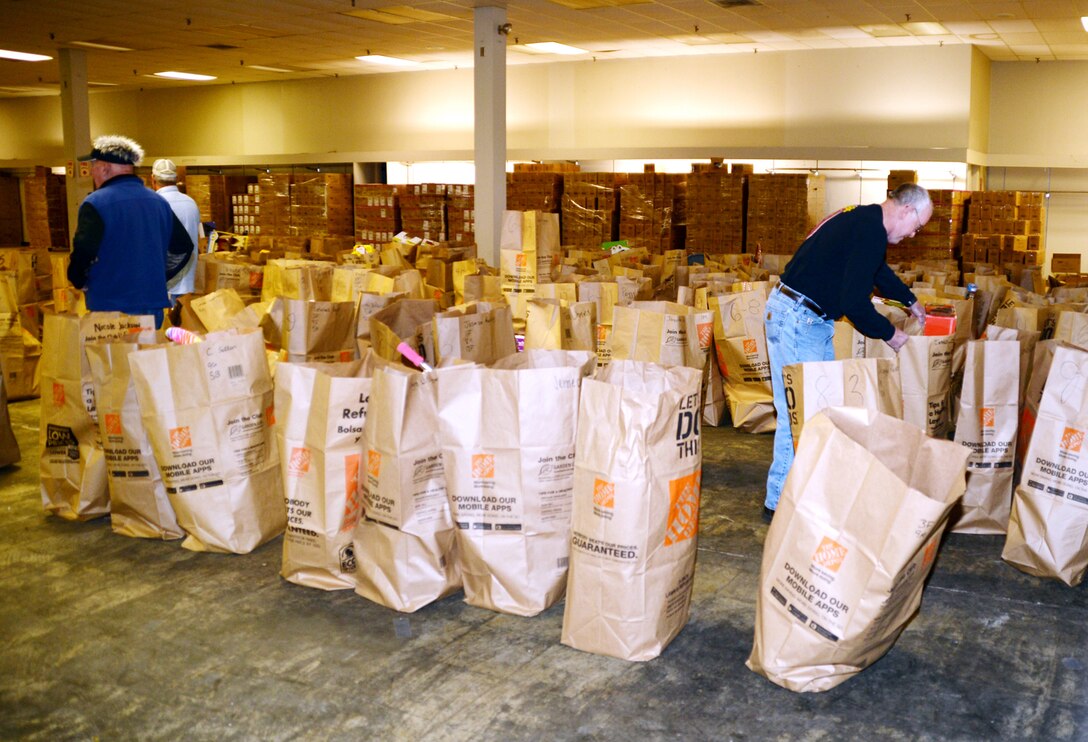 Marine Corps Toys for Tots volunteers sort through bags filled with toys at the Albany, Ga., distribution site Dec. 20, 2016.